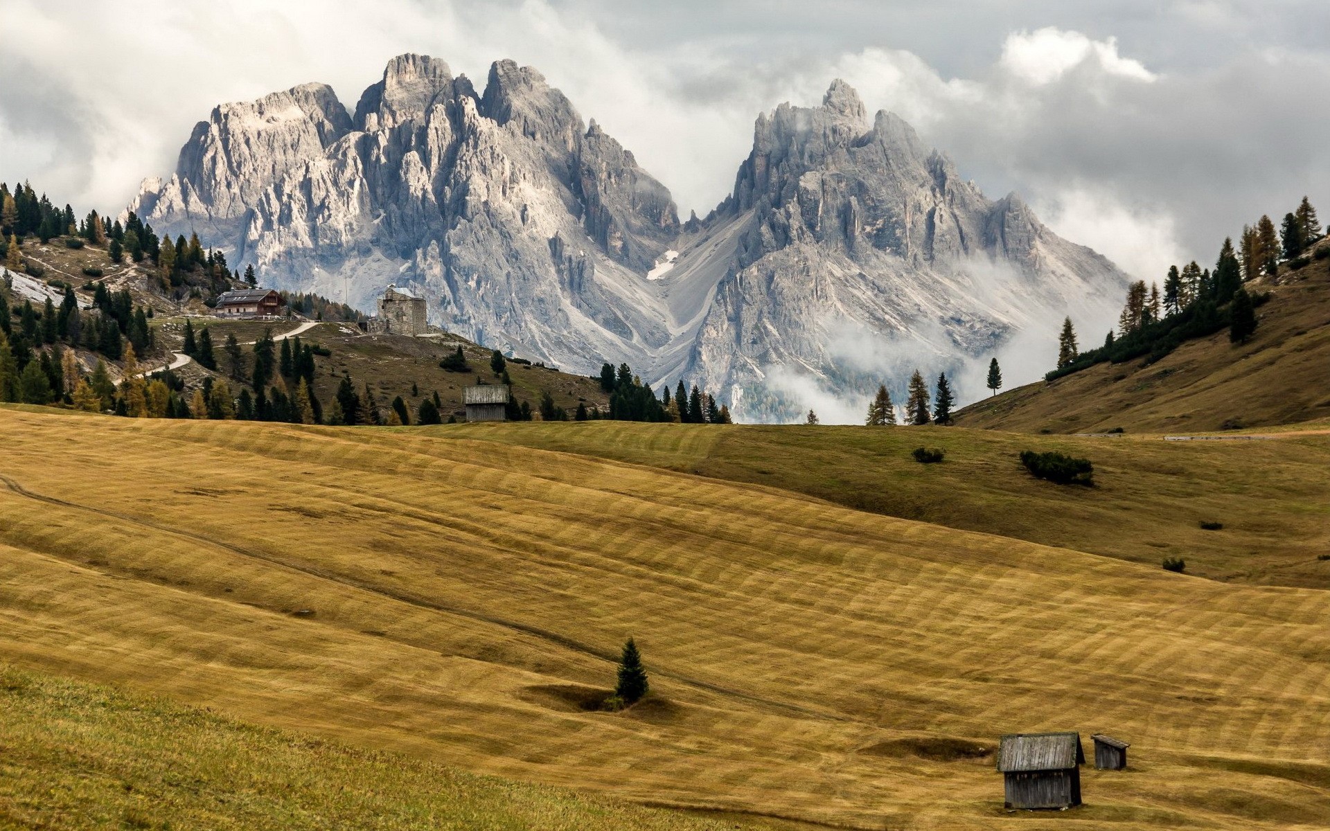 Mountain landscape with fields and buildings in South Tyrol, Italy HD Wallpaper