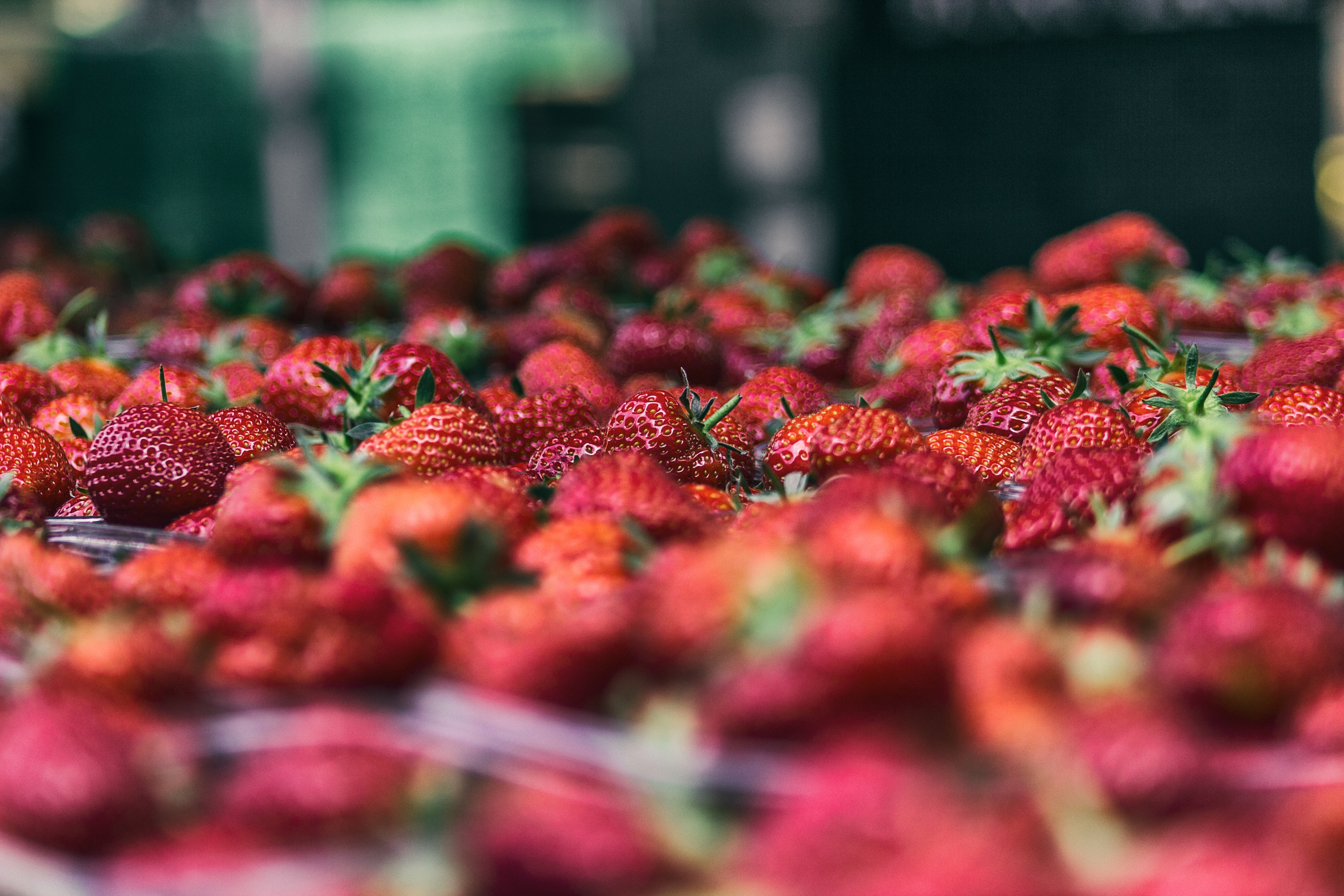A large batch of fresh strawberries in a market HD Wallpaper