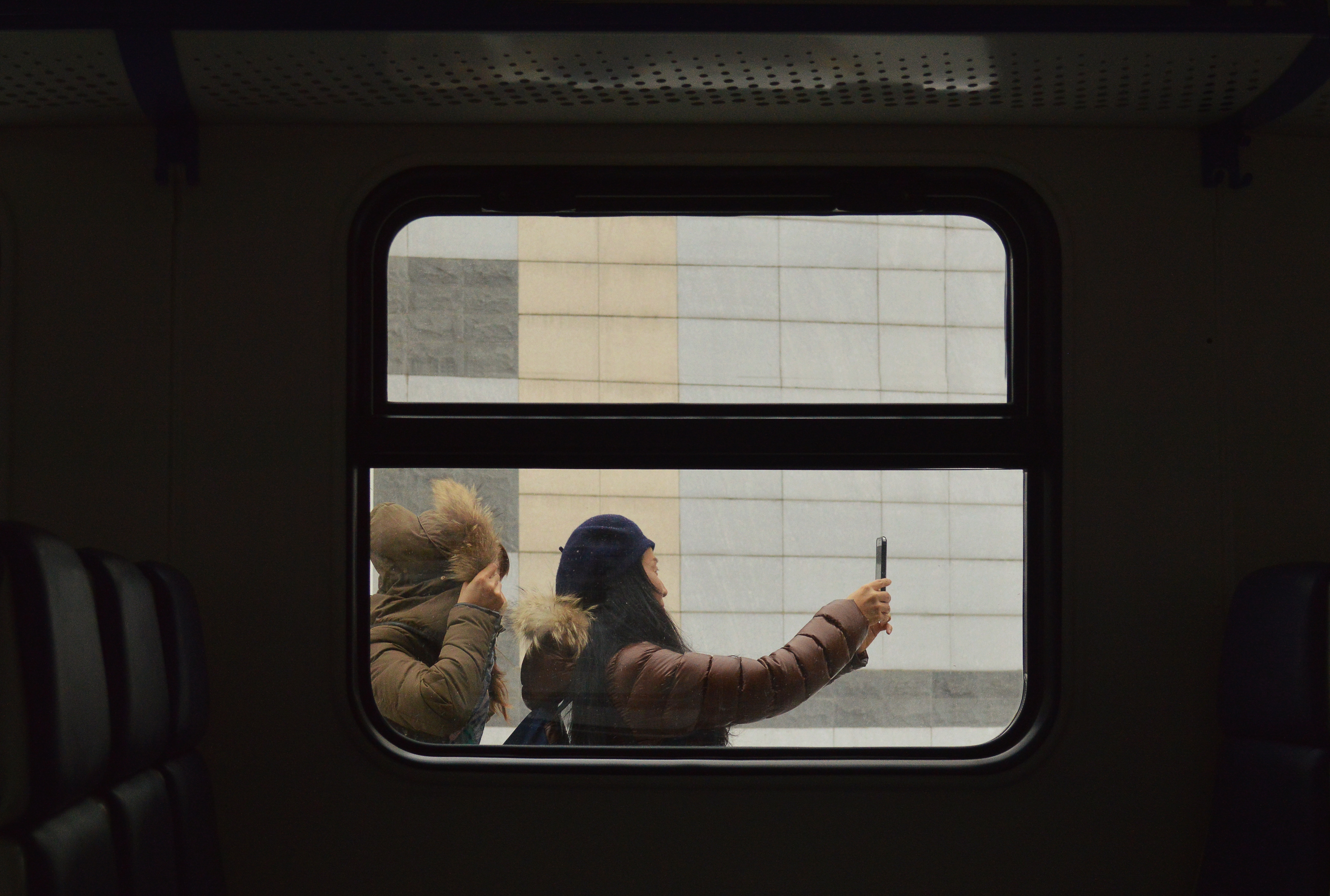 Two women taking a selfie on a train HD Wallpaper