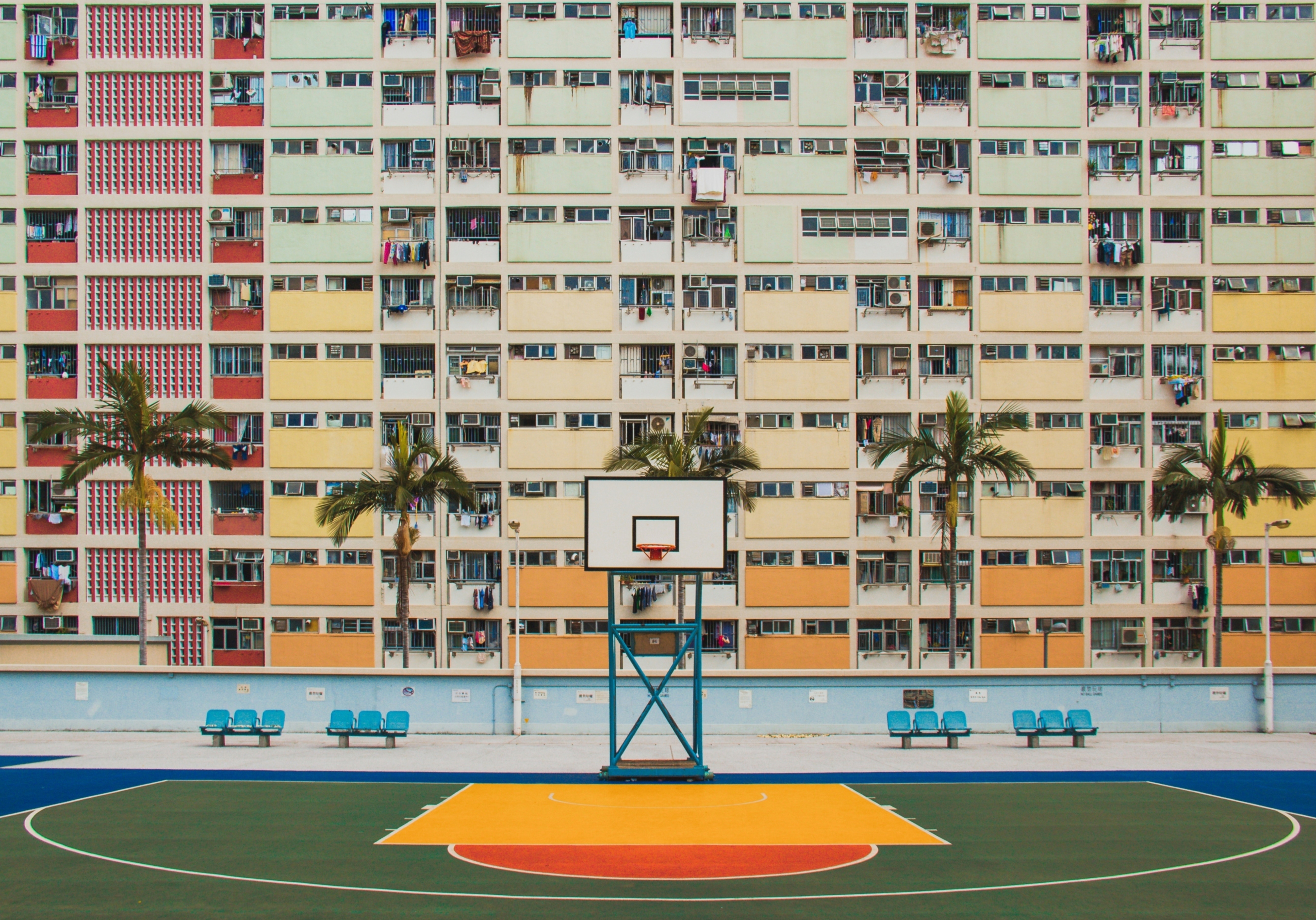 Colorful apartment buildings and basketball court in Hong Kong HD Wallpaper