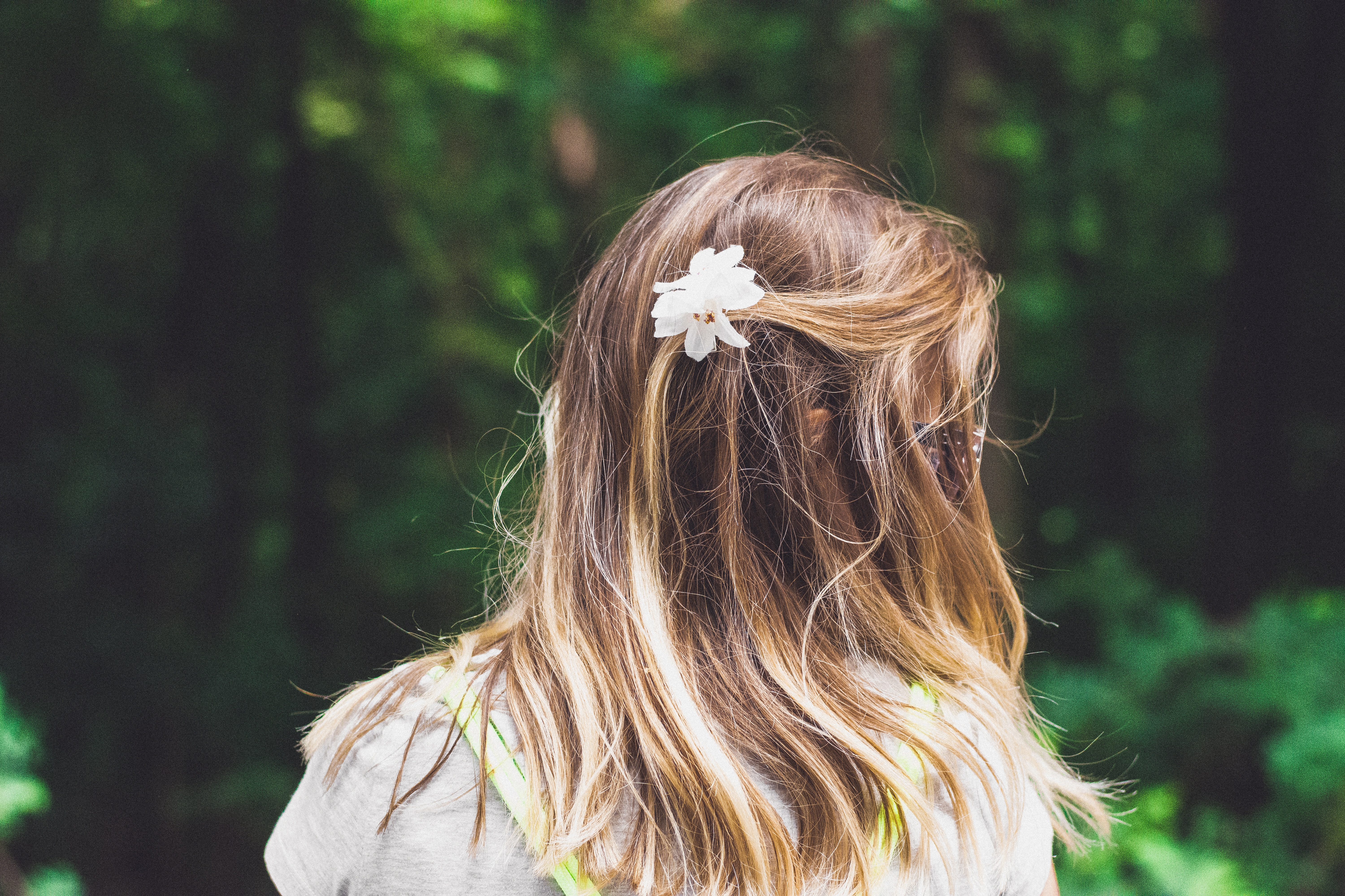 Girl with flower in hair in forest HD Wallpaper