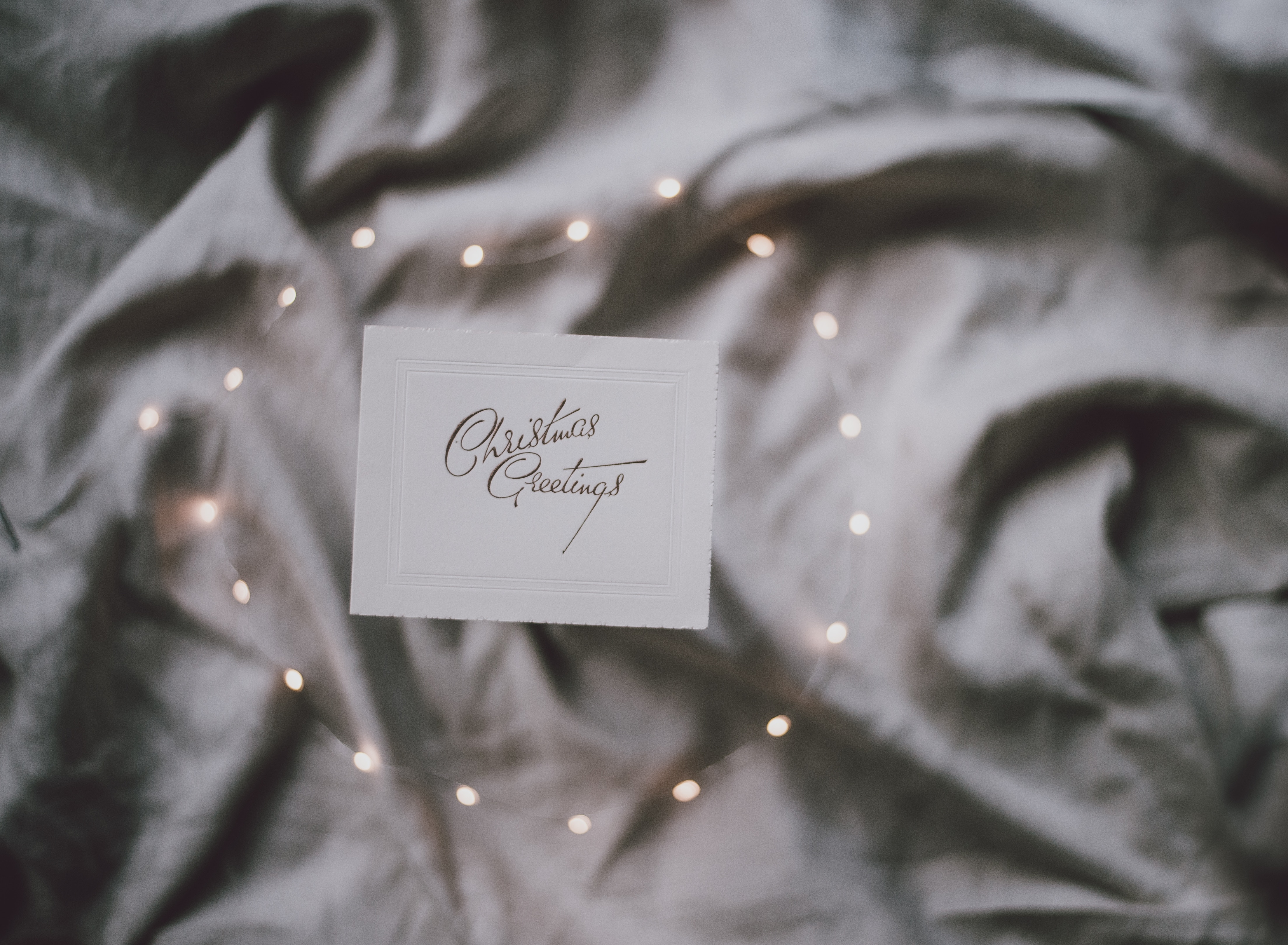 Christmas Greetings card with fairy lights on sheets HD Wallpaper
