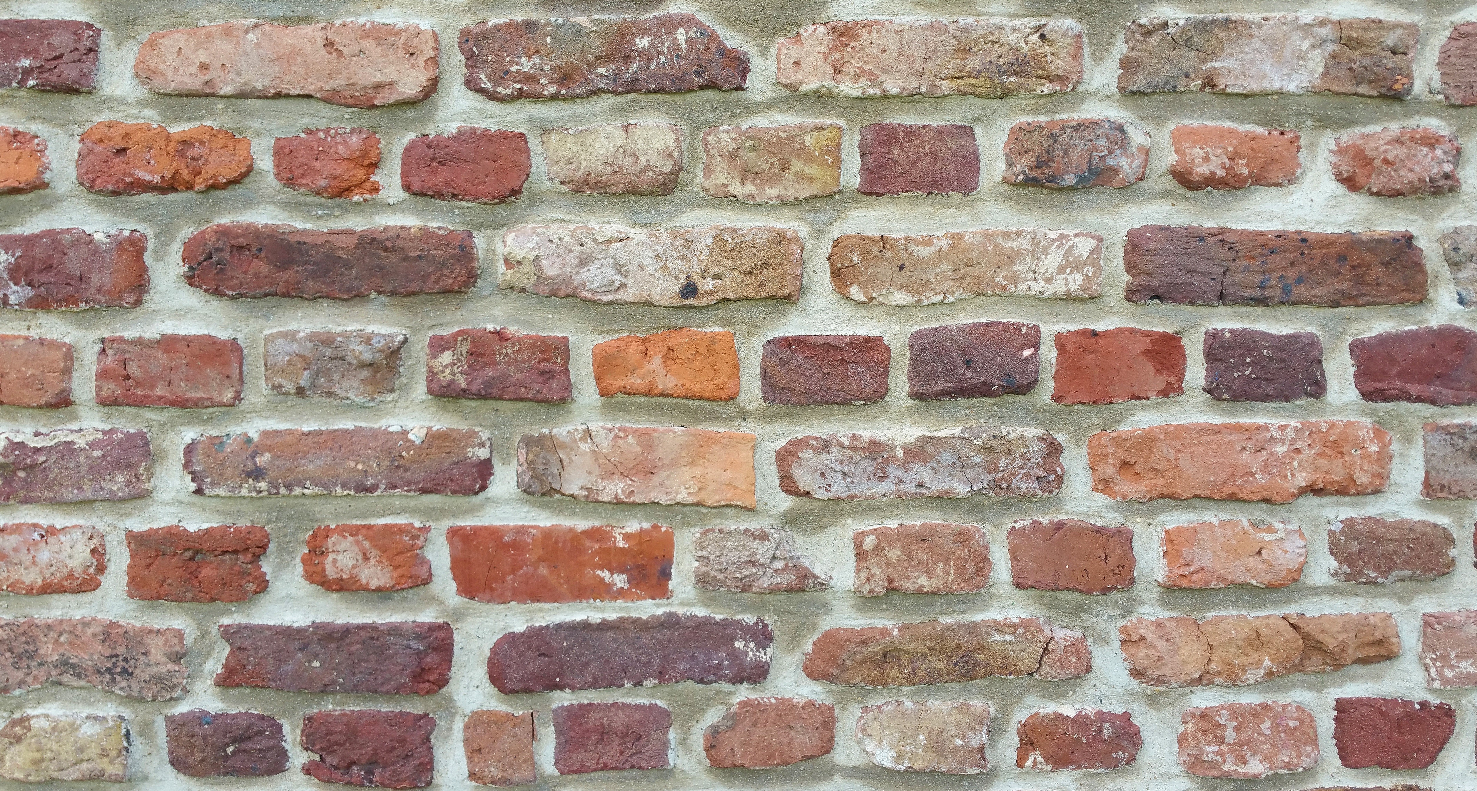 Close-up of a weathered brick wall texture HD Wallpaper