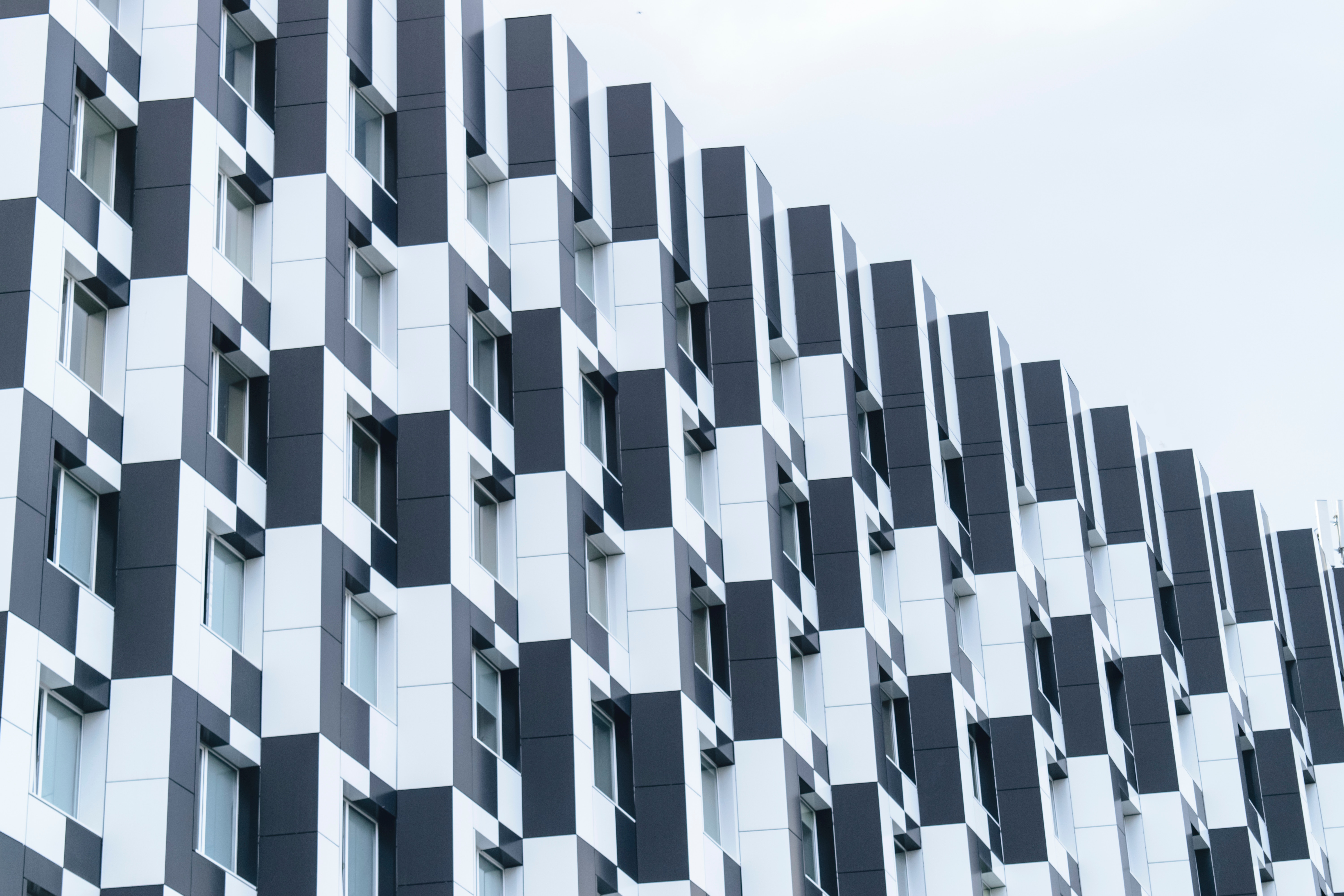 Black and white checkered building facade with windows HD Wallpaper
