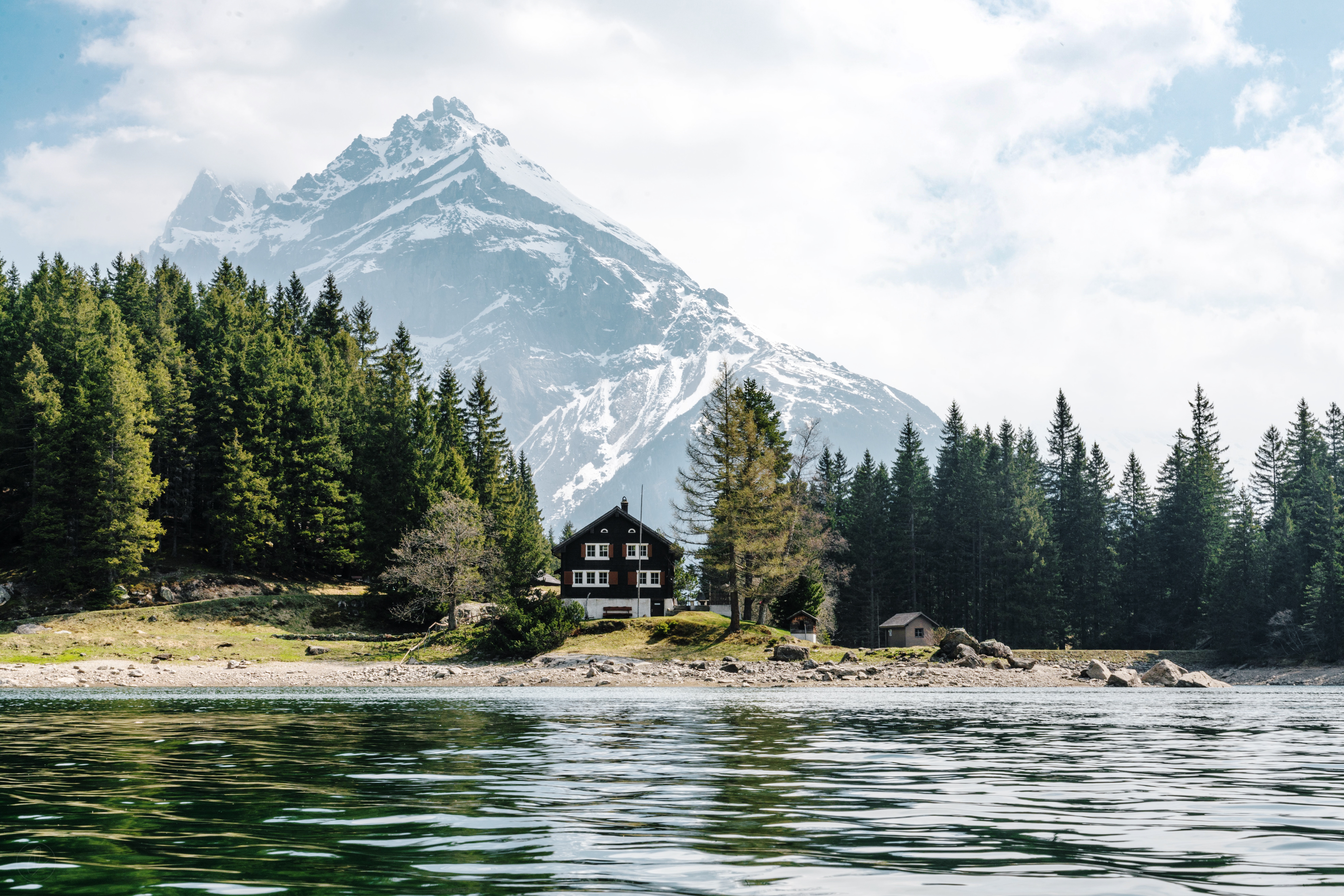 House by a lake with a snowy mountain in Switzerland HD Wallpaper