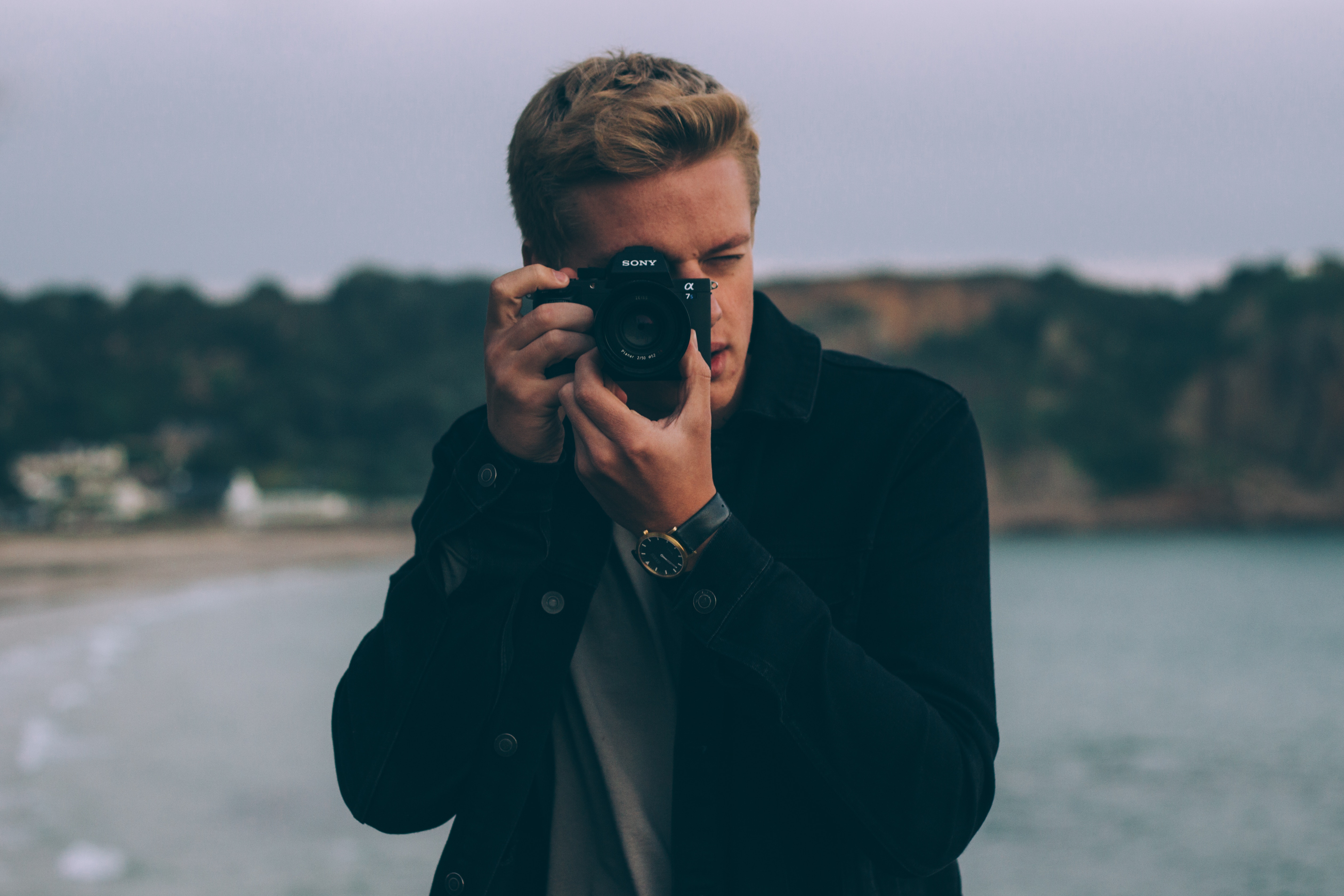 Man with Sony camera taking a photo at the beach HD Wallpaper
