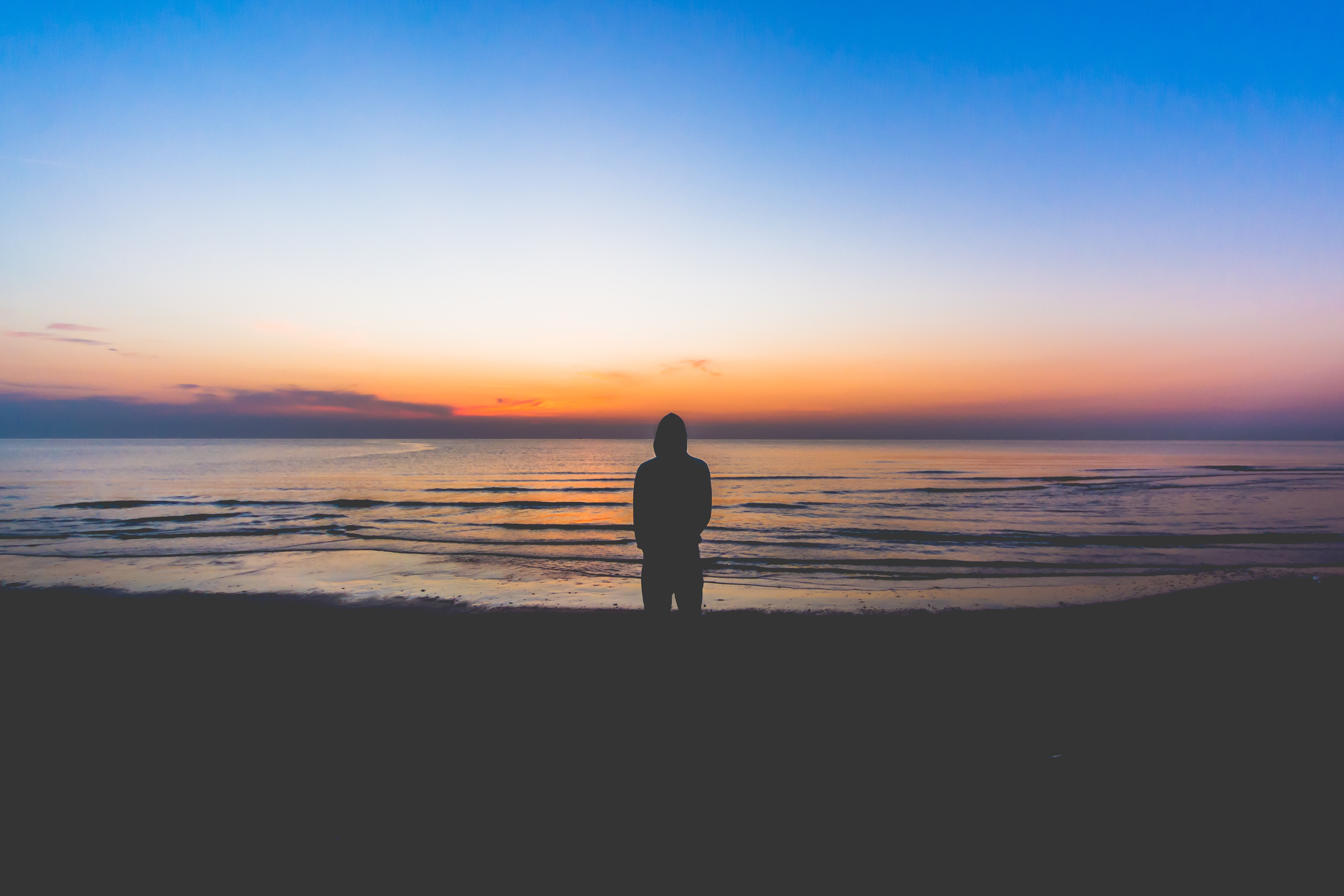 Silhouette Standing by Calm Ocean at Sunset HD Wallpaper
