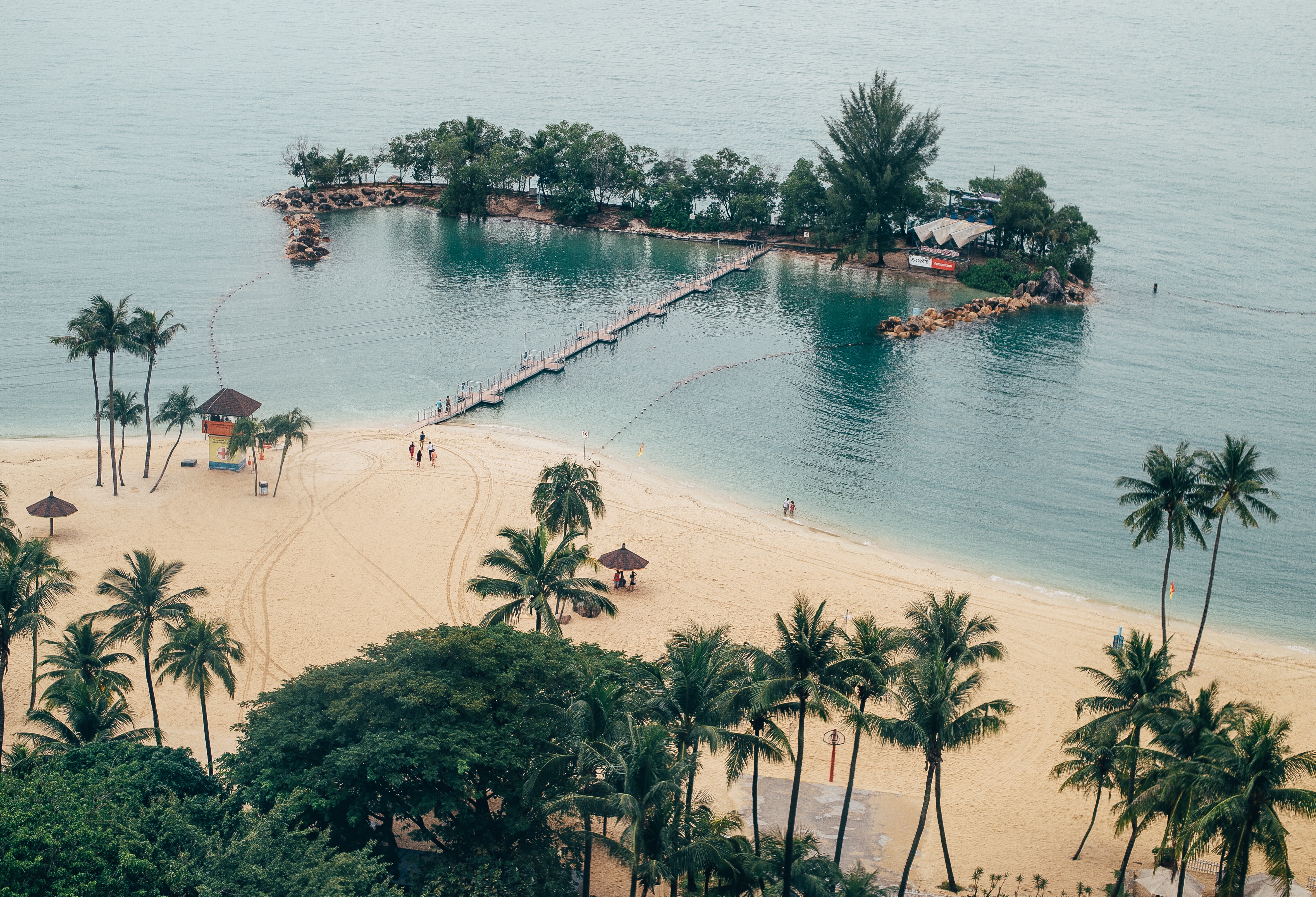 Tropical island with a pier and sandy beach HD Wallpaper