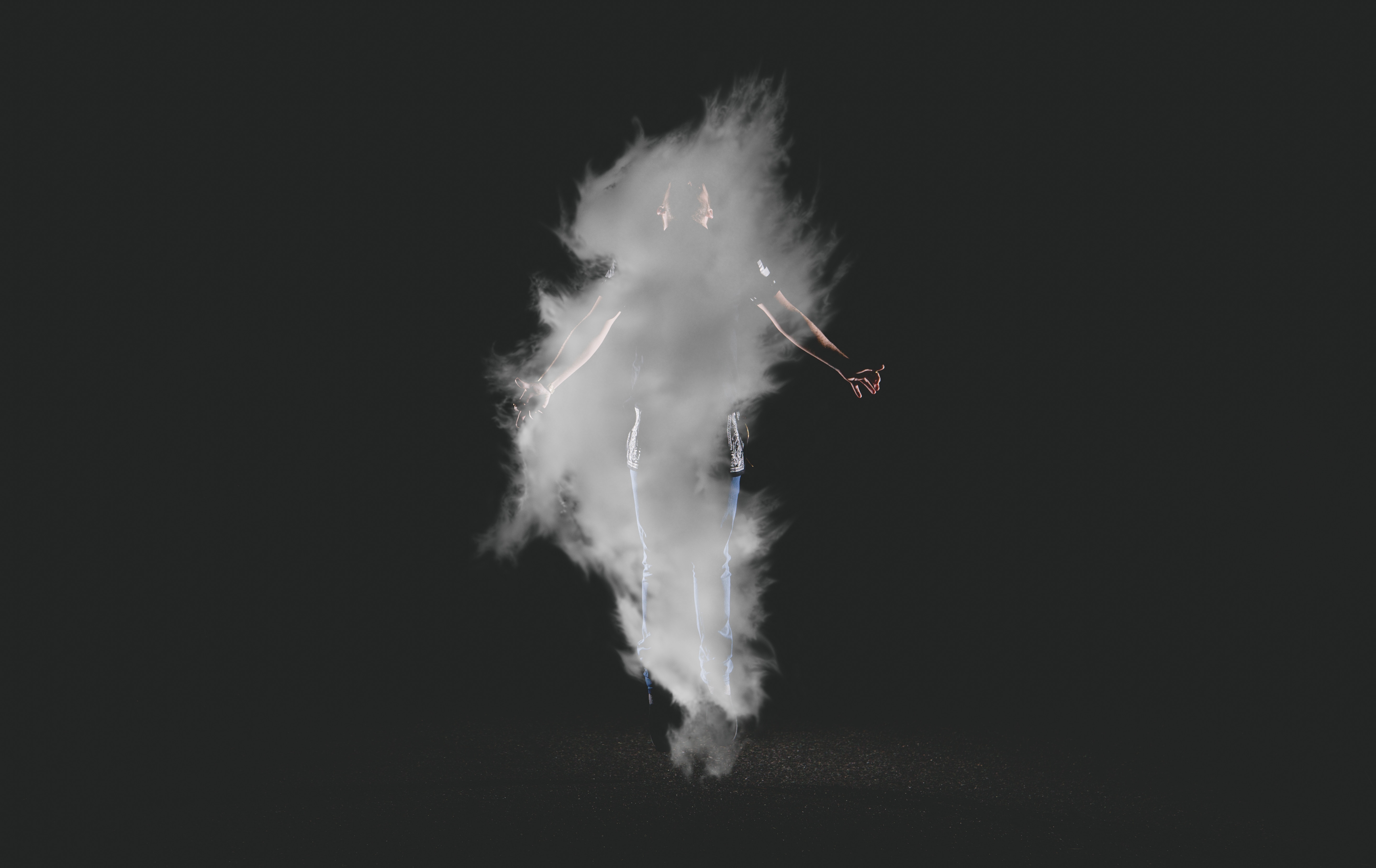 Person engulfed in smoke with arms outstretched HD Wallpaper