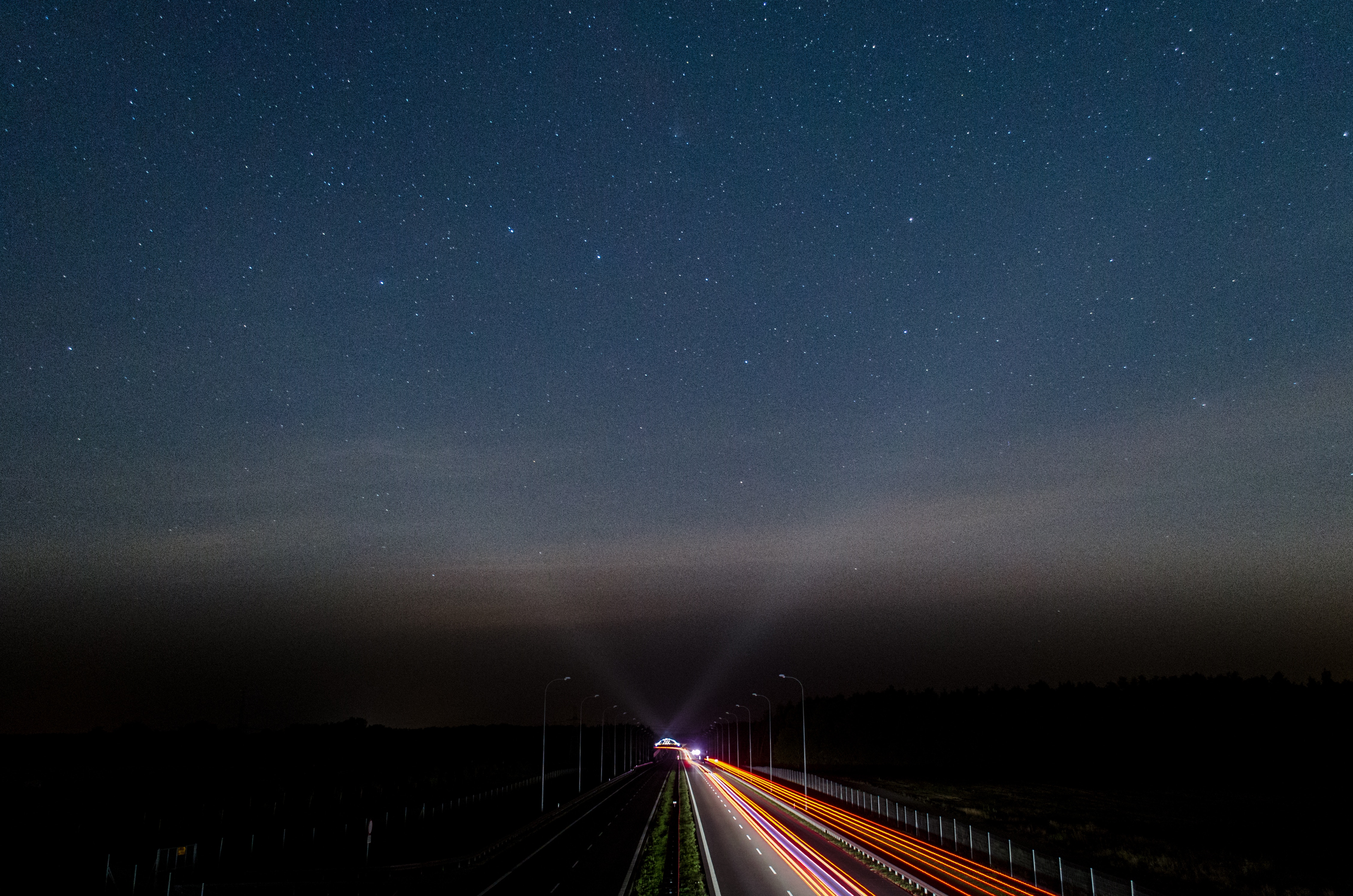 Highway at night with stars and light trails HD Wallpaper
