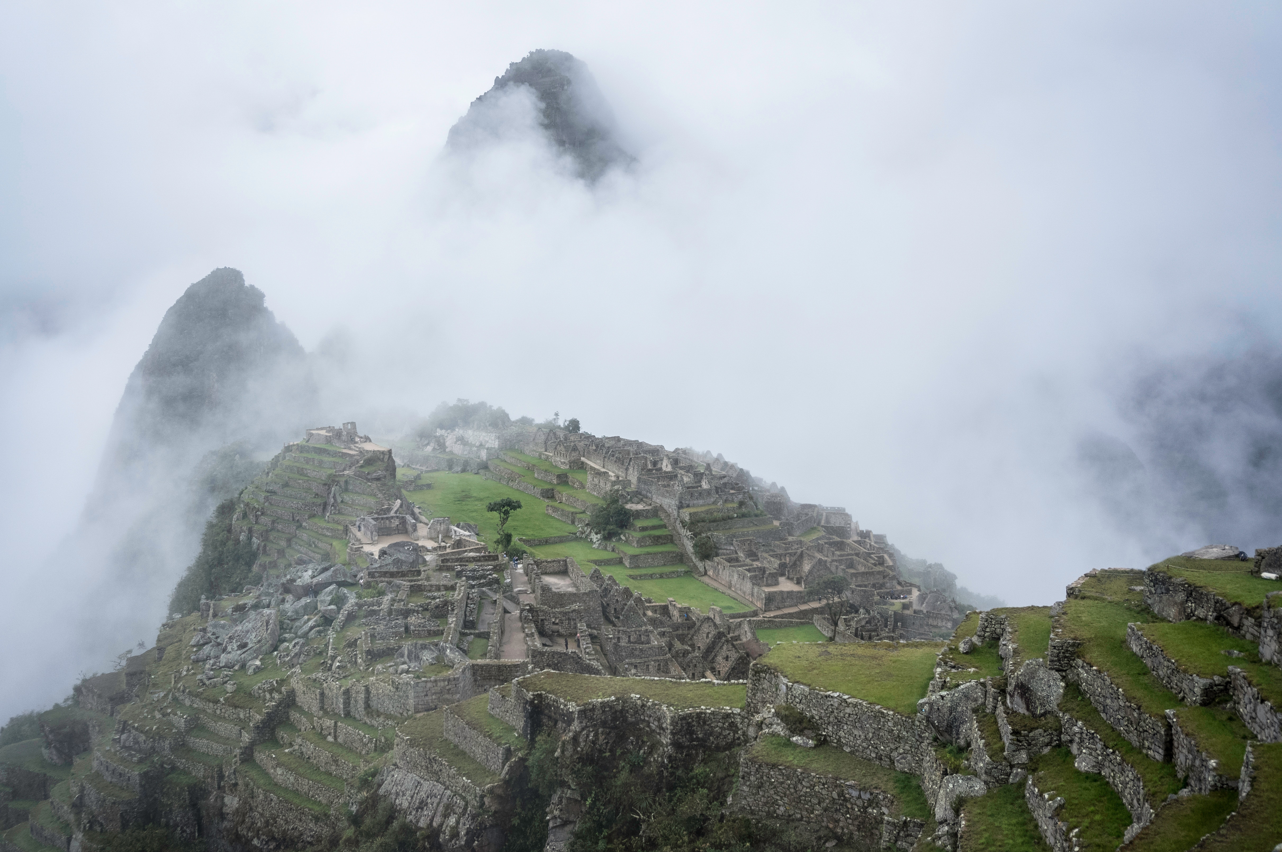 Machu Picchu ruins shrouded in fog HD Wallpaper