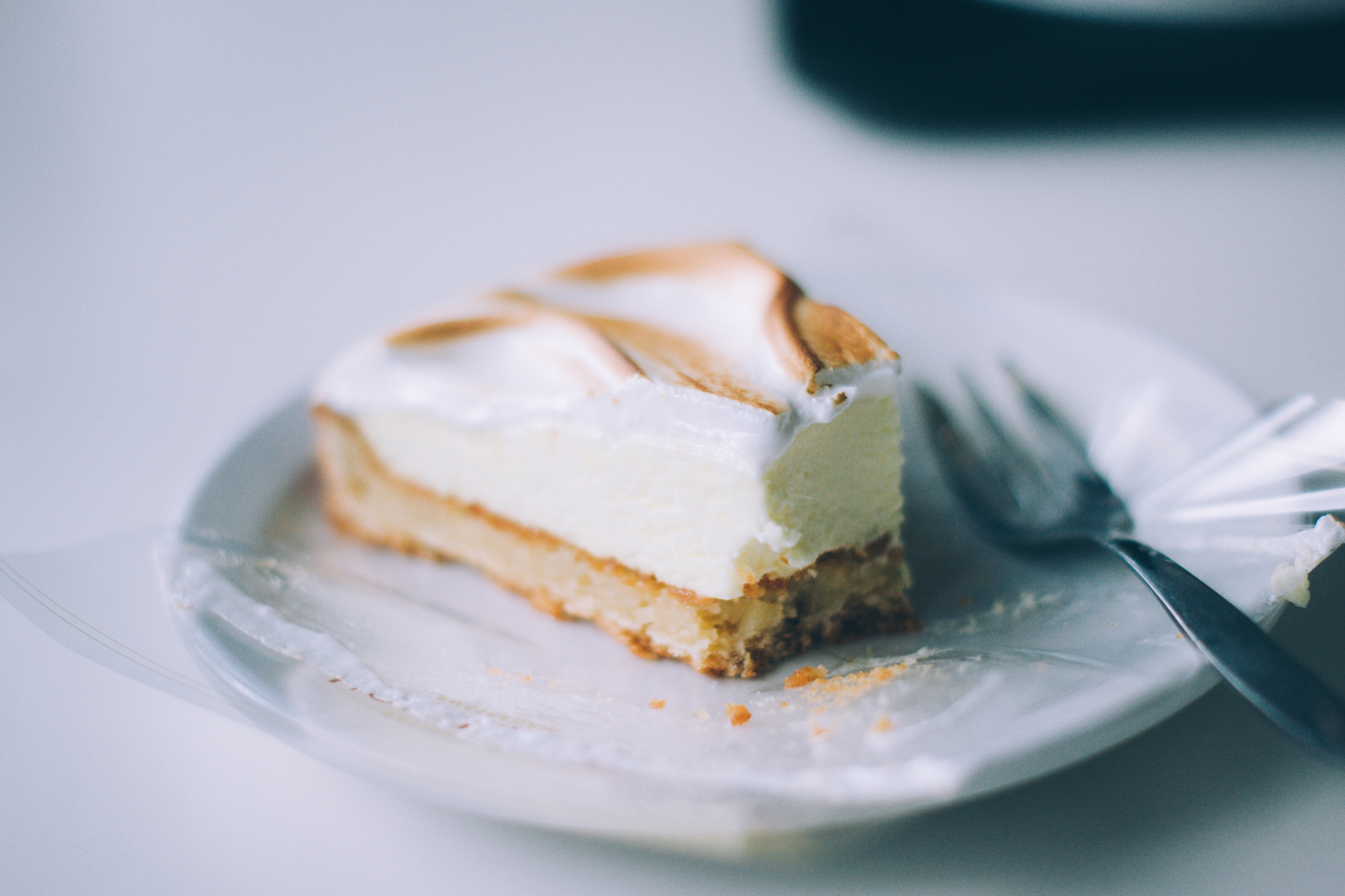 Slice of cheesecake with meringue on a plate with a fork HD Wallpaper