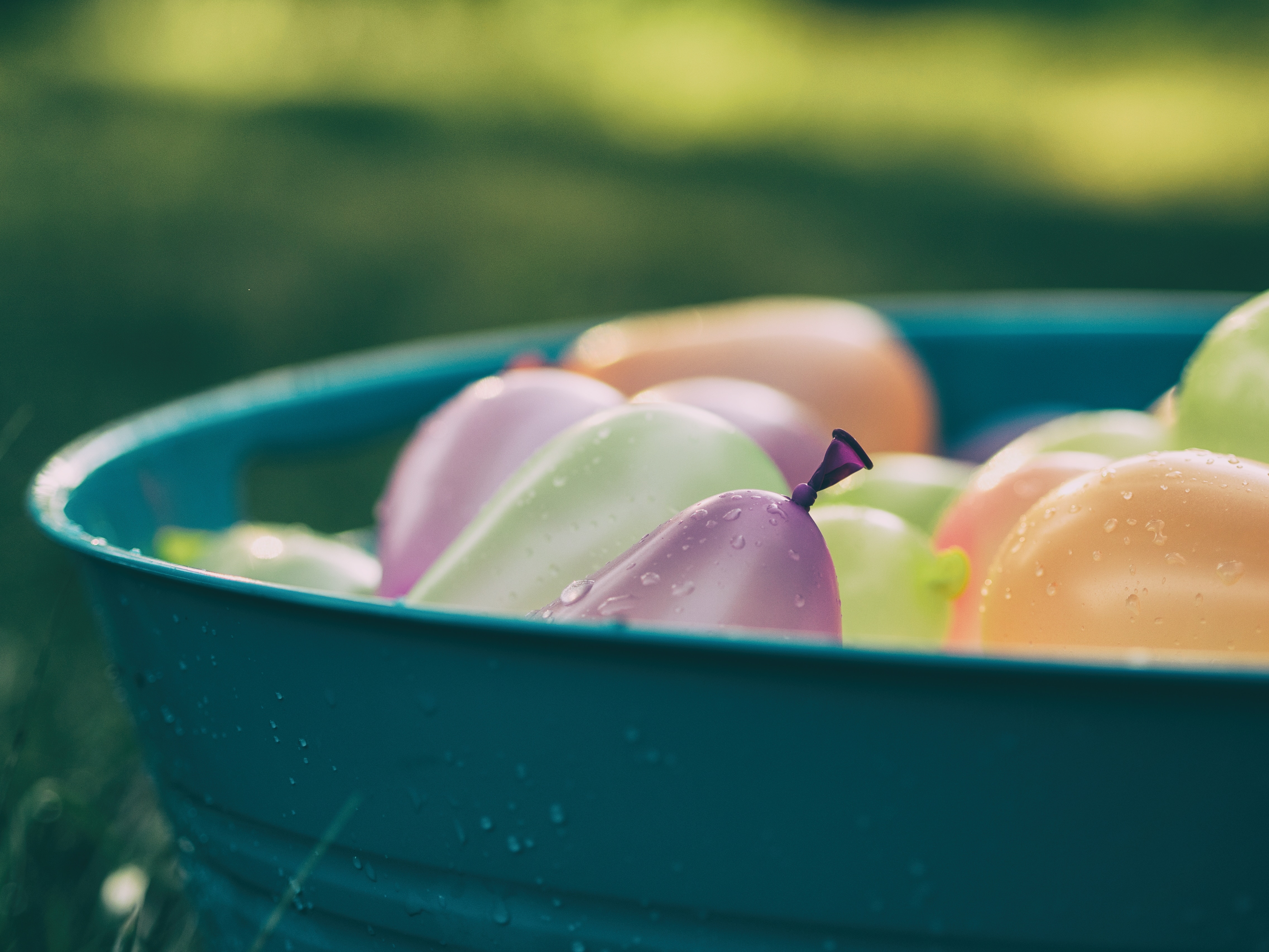 Water balloons in a blue tub HD Wallpaper