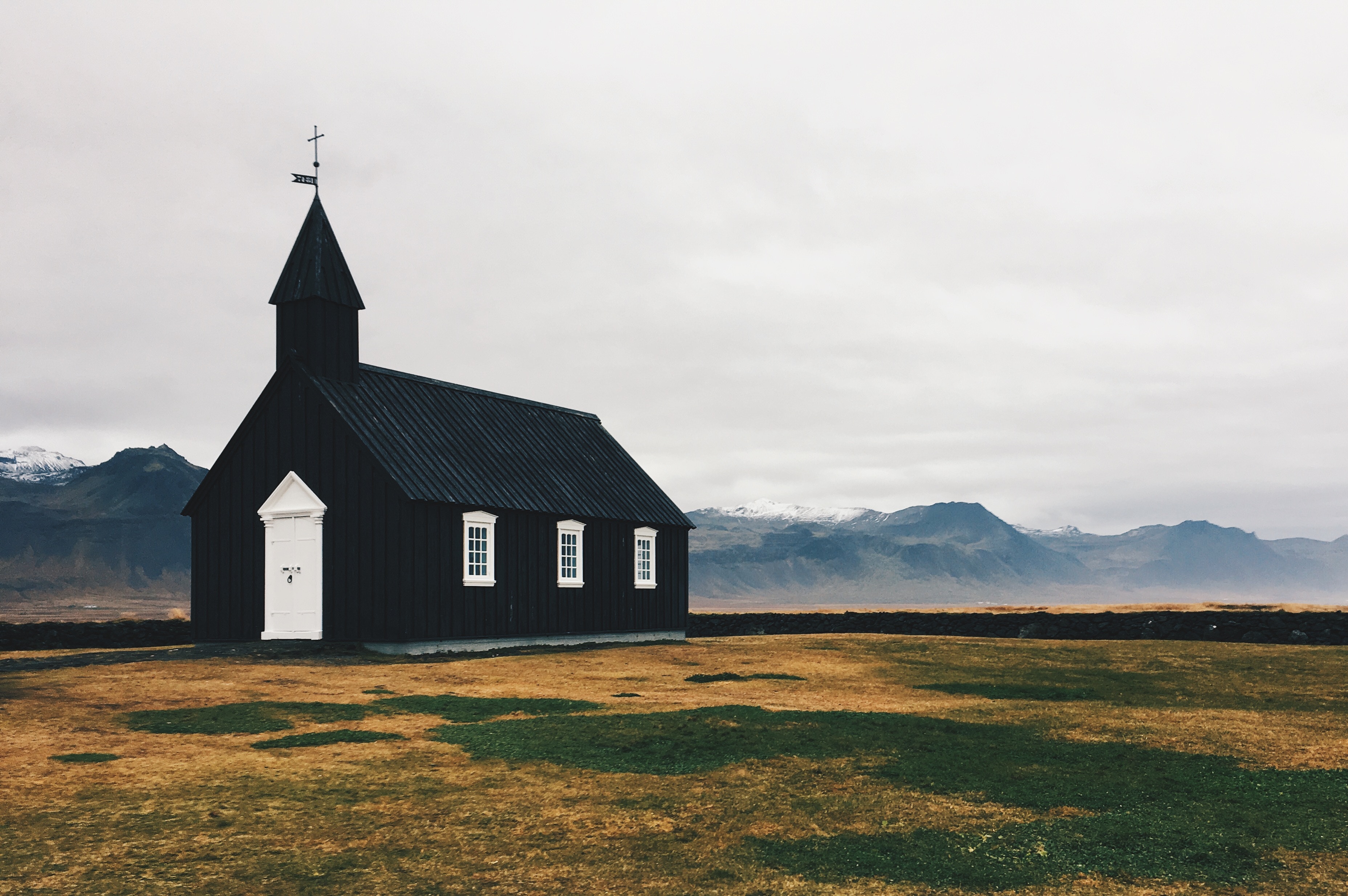 Black church in Iceland with mountains in the background HD Wallpaper