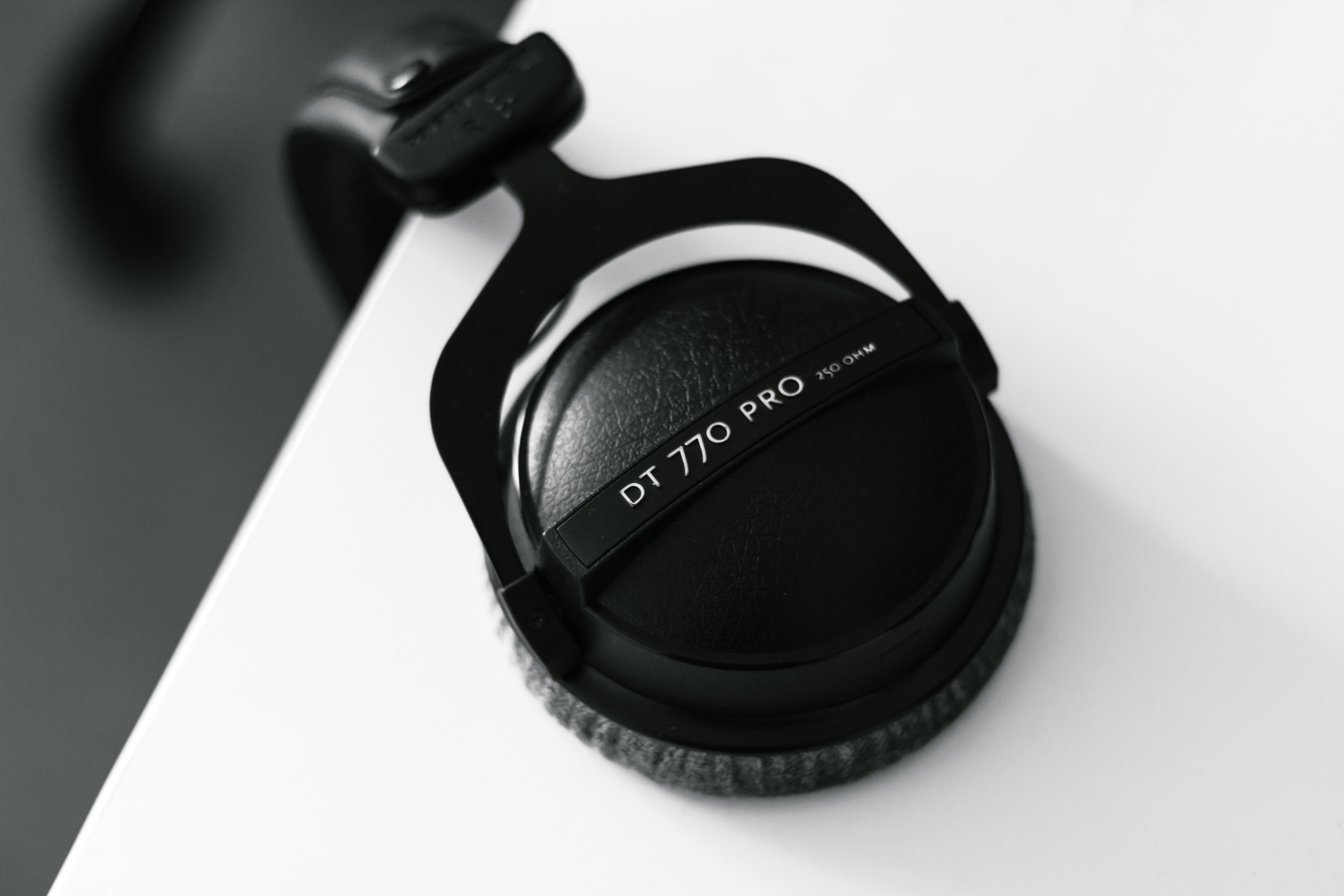 Beyerdynamic DT 770 PRO headphones on a white surface HD Wallpaper