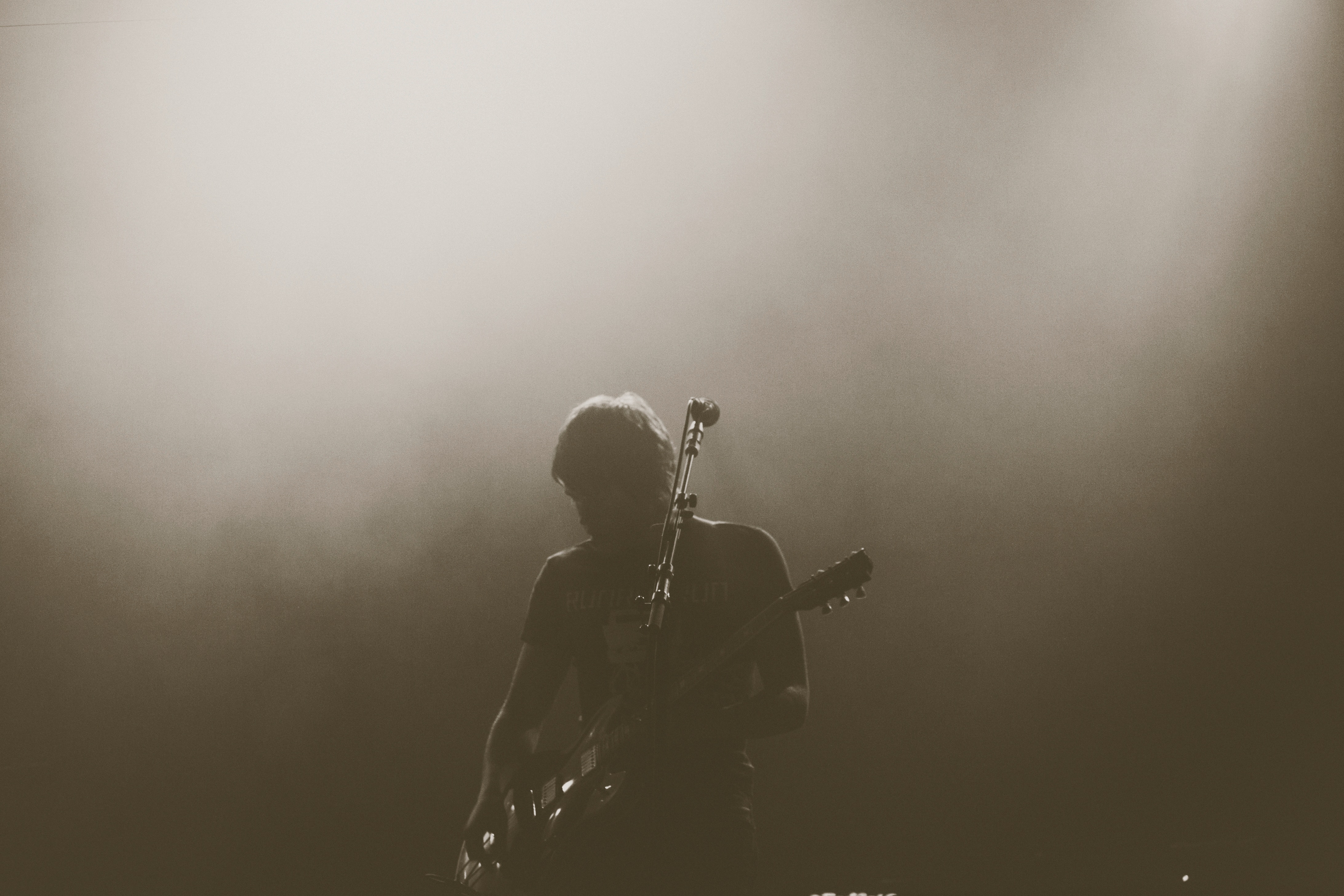 Guitarist performing on stage with fog HD Wallpaper