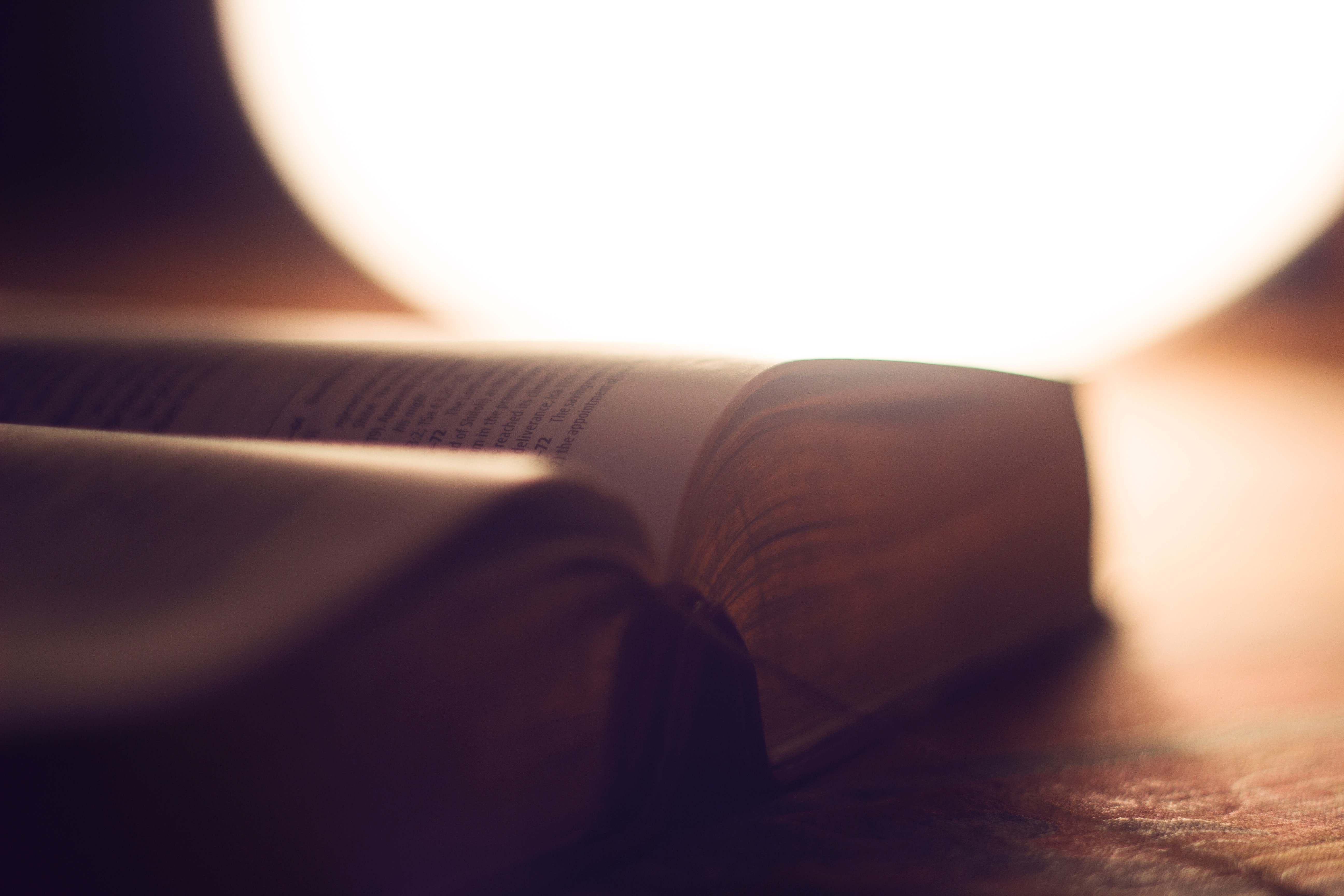 Open book with bright light behind it HD Wallpaper