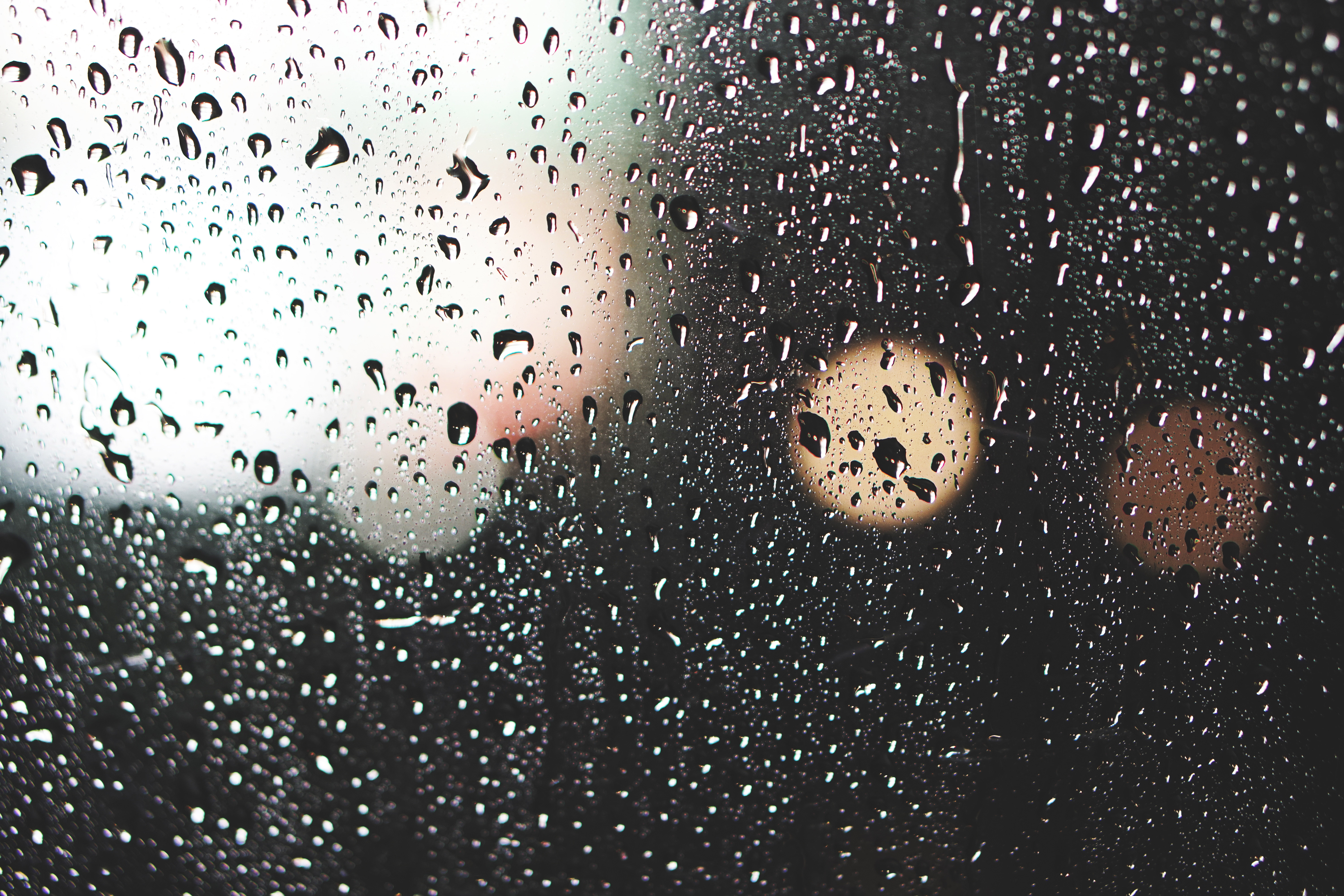 Raindrops on glass with bokeh lights HD Wallpaper