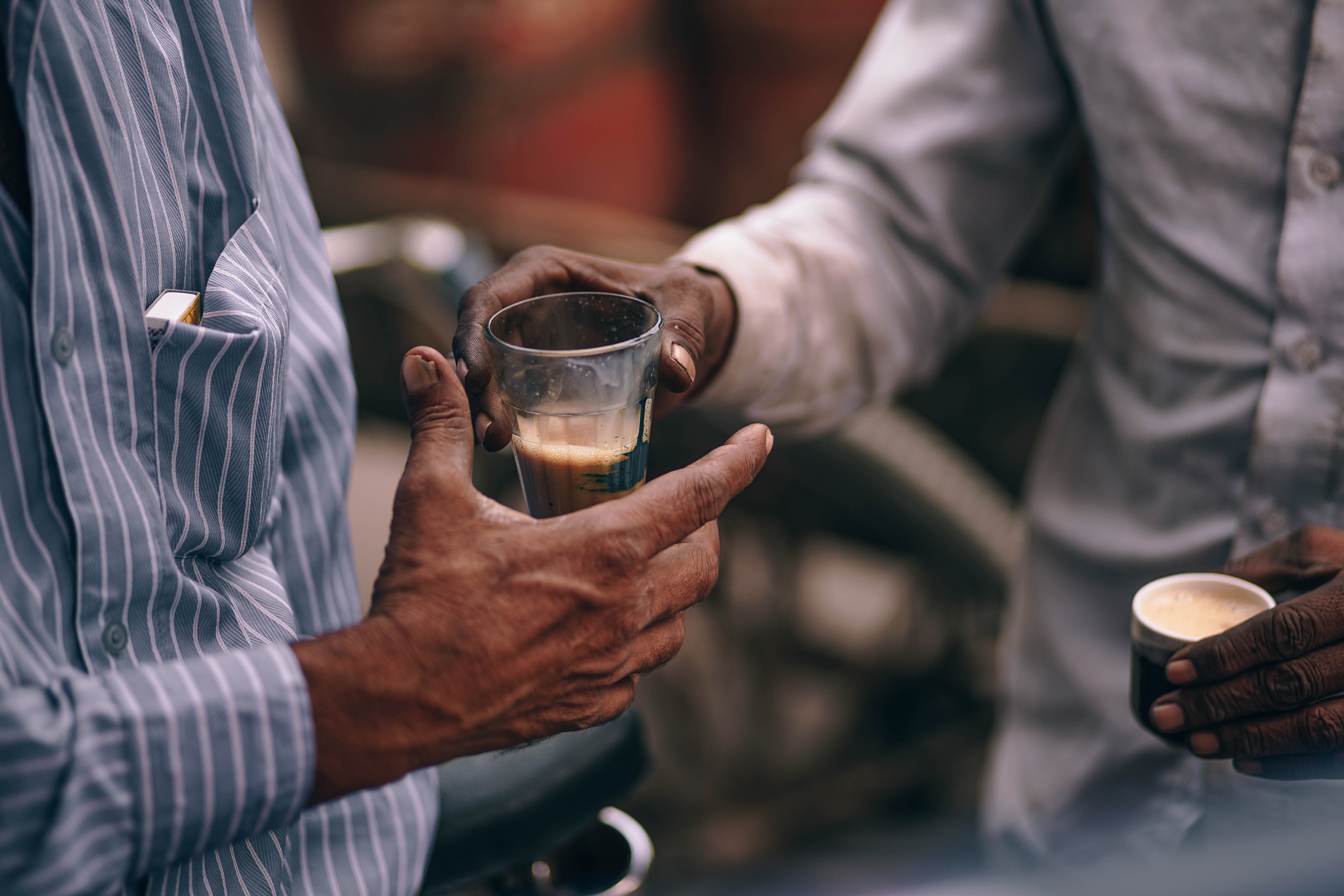 Two men sharing a cup of tea HD Wallpaper