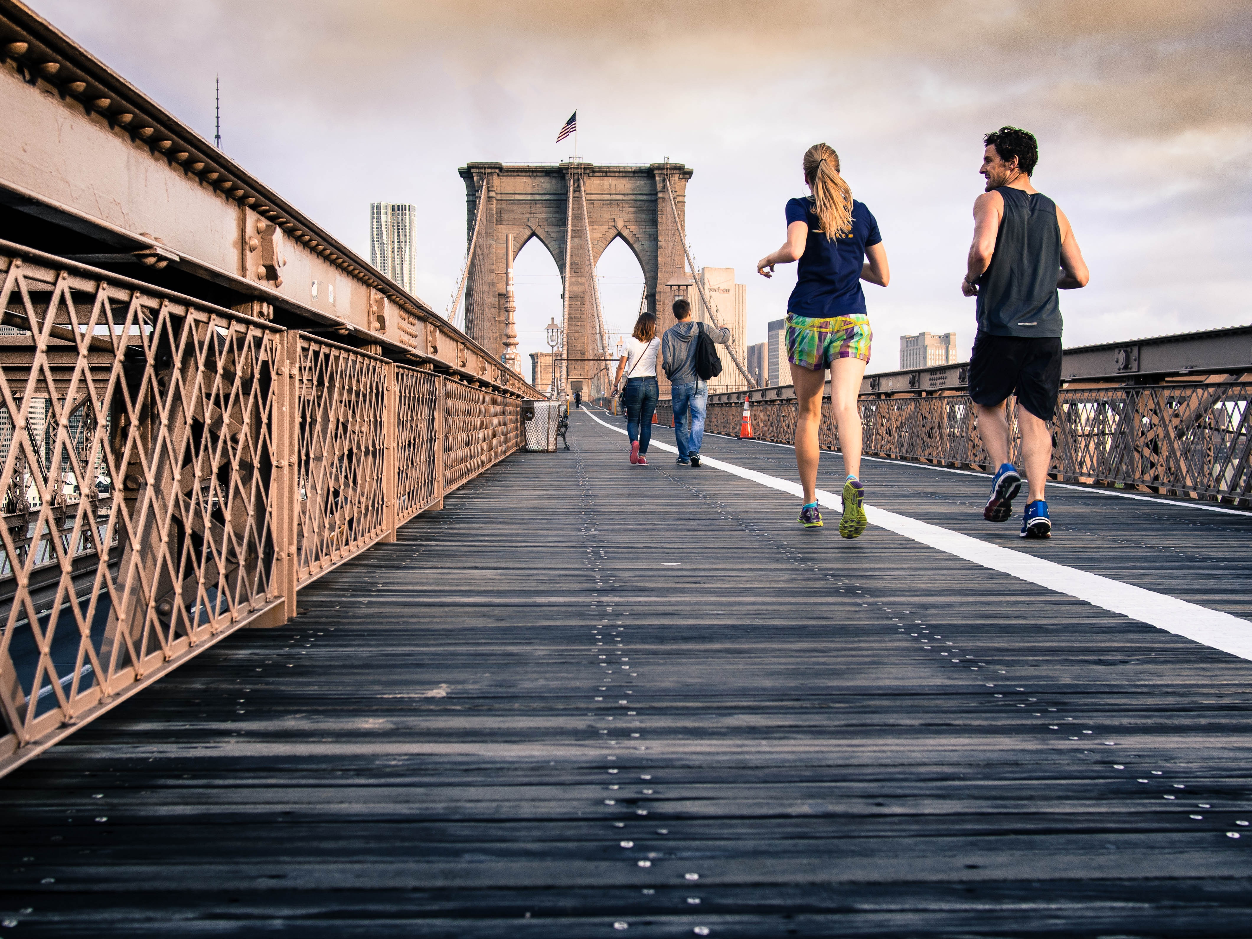 People running on the Brooklyn Bridge HD Wallpaper