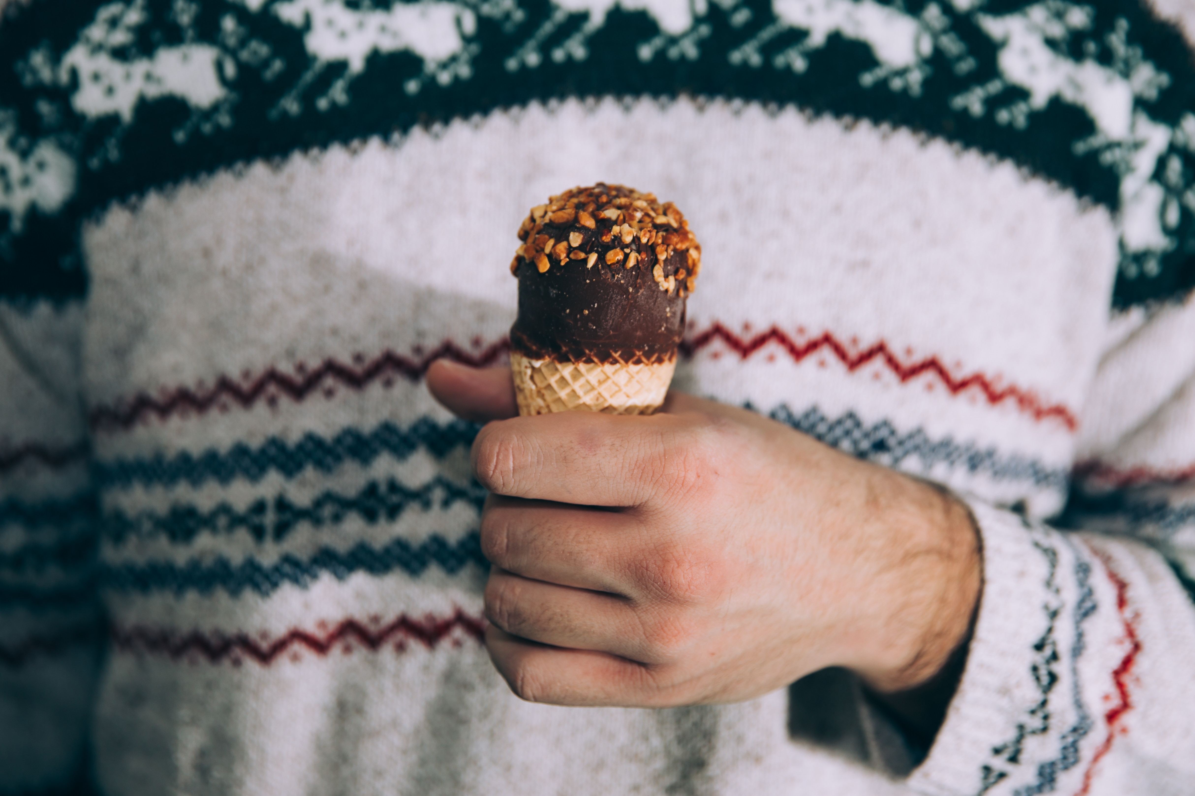 Man in Christmas Sweater Holding Chocolate Ice Cream Cone HD Wallpaper