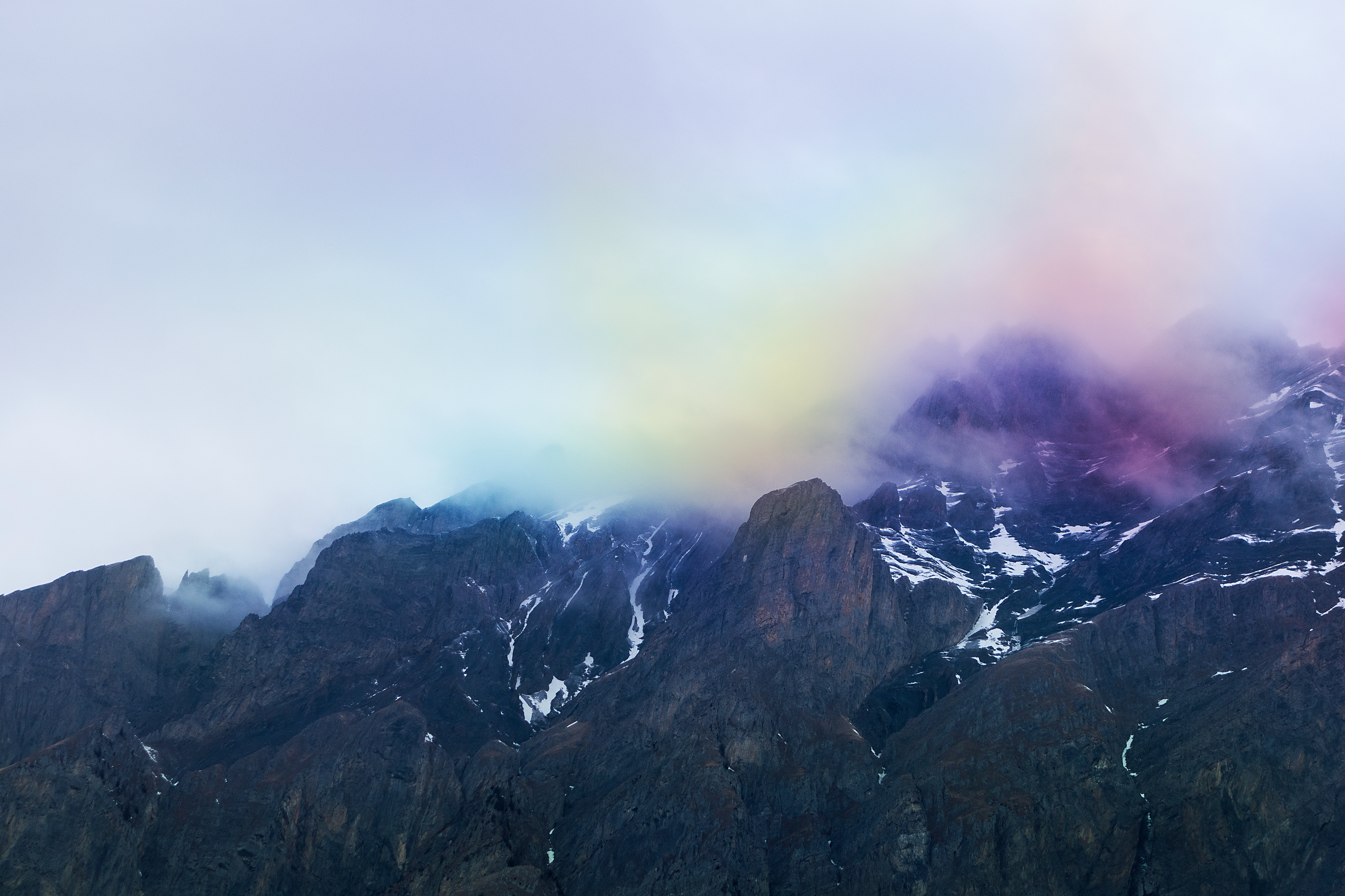 Mountain range with colorful mist and snow HD Wallpaper