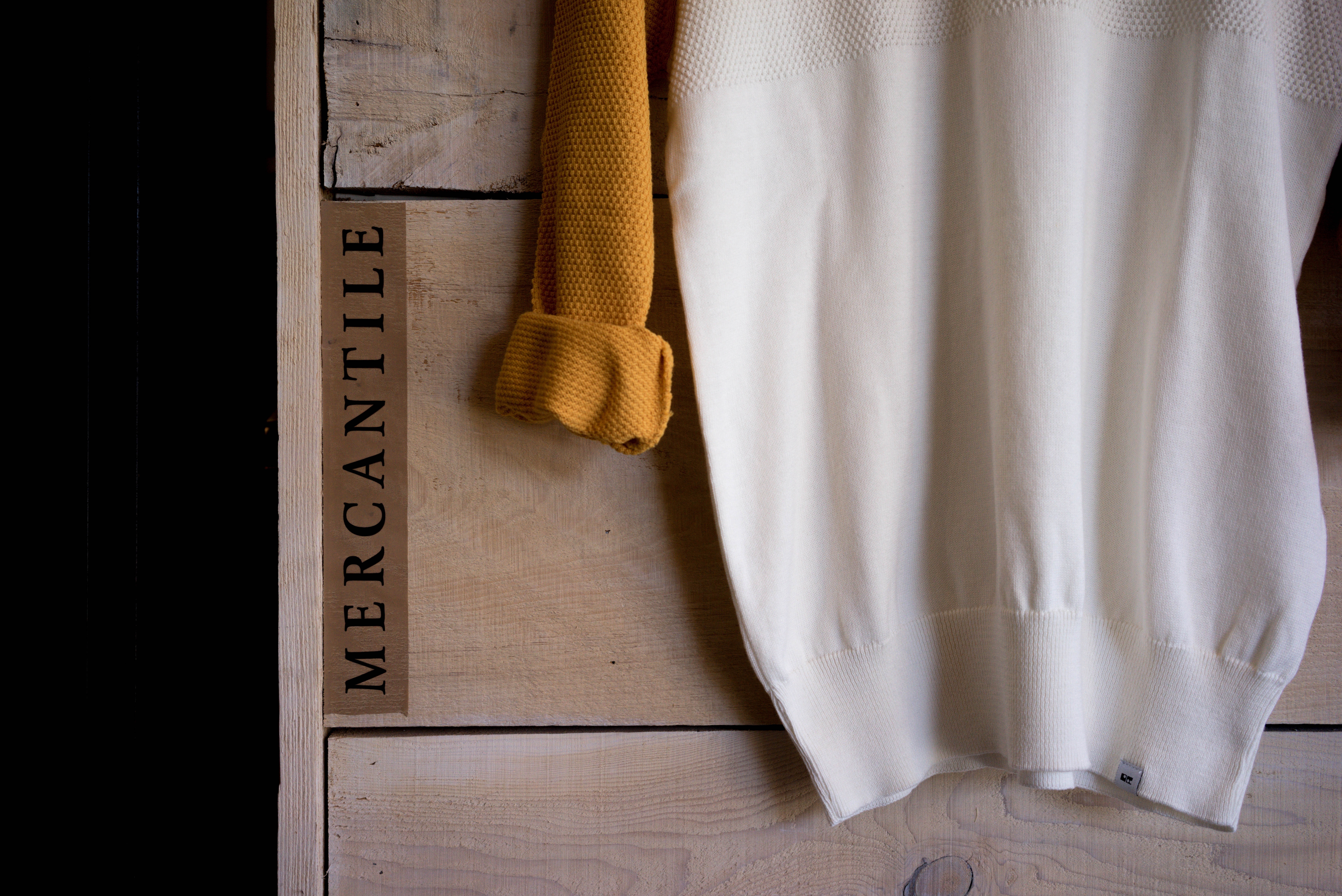 Mercantile wooden box with yellow and white sweaters HD Wallpaper