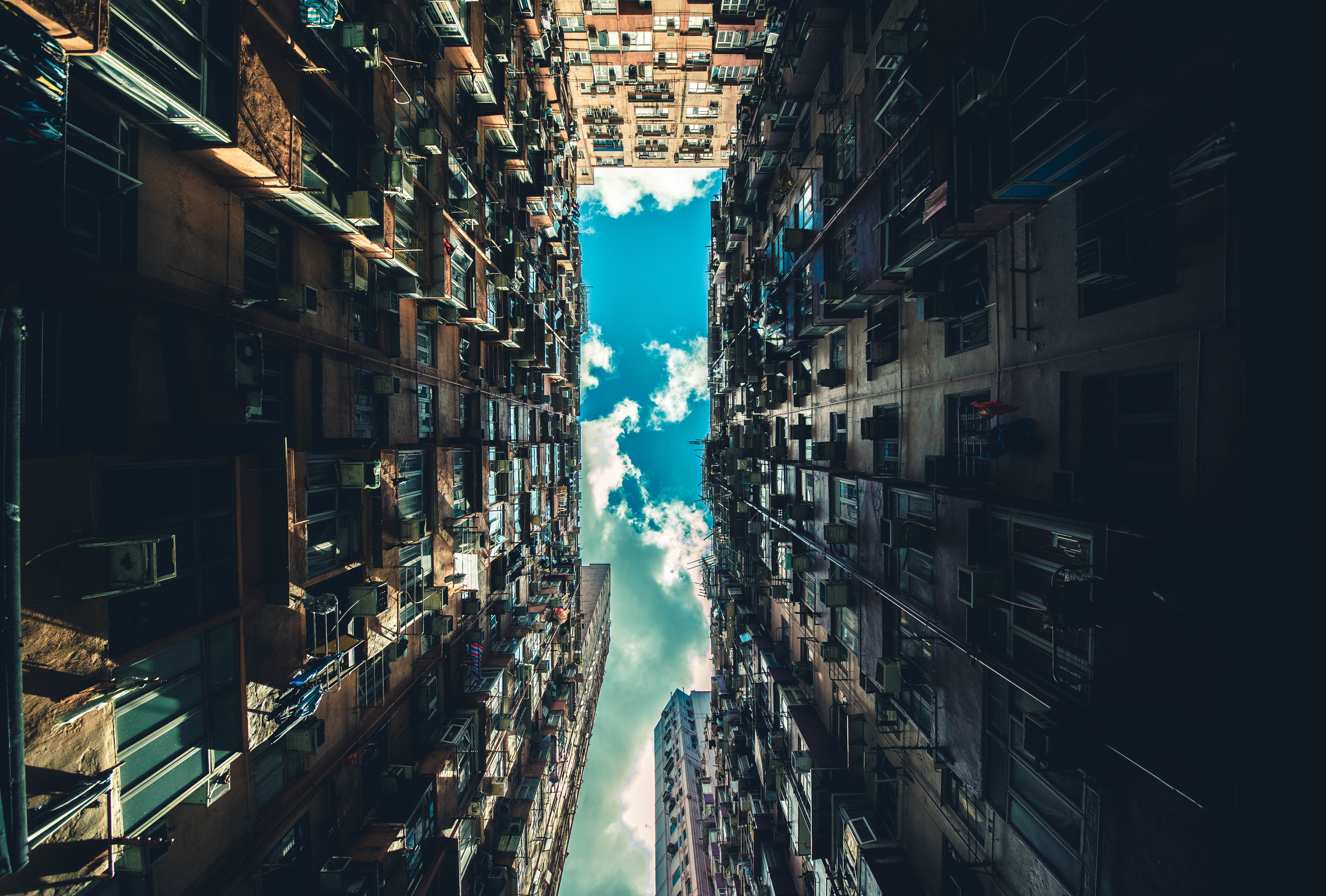 Looking up at dense apartment buildings in Hong Kong HD Wallpaper