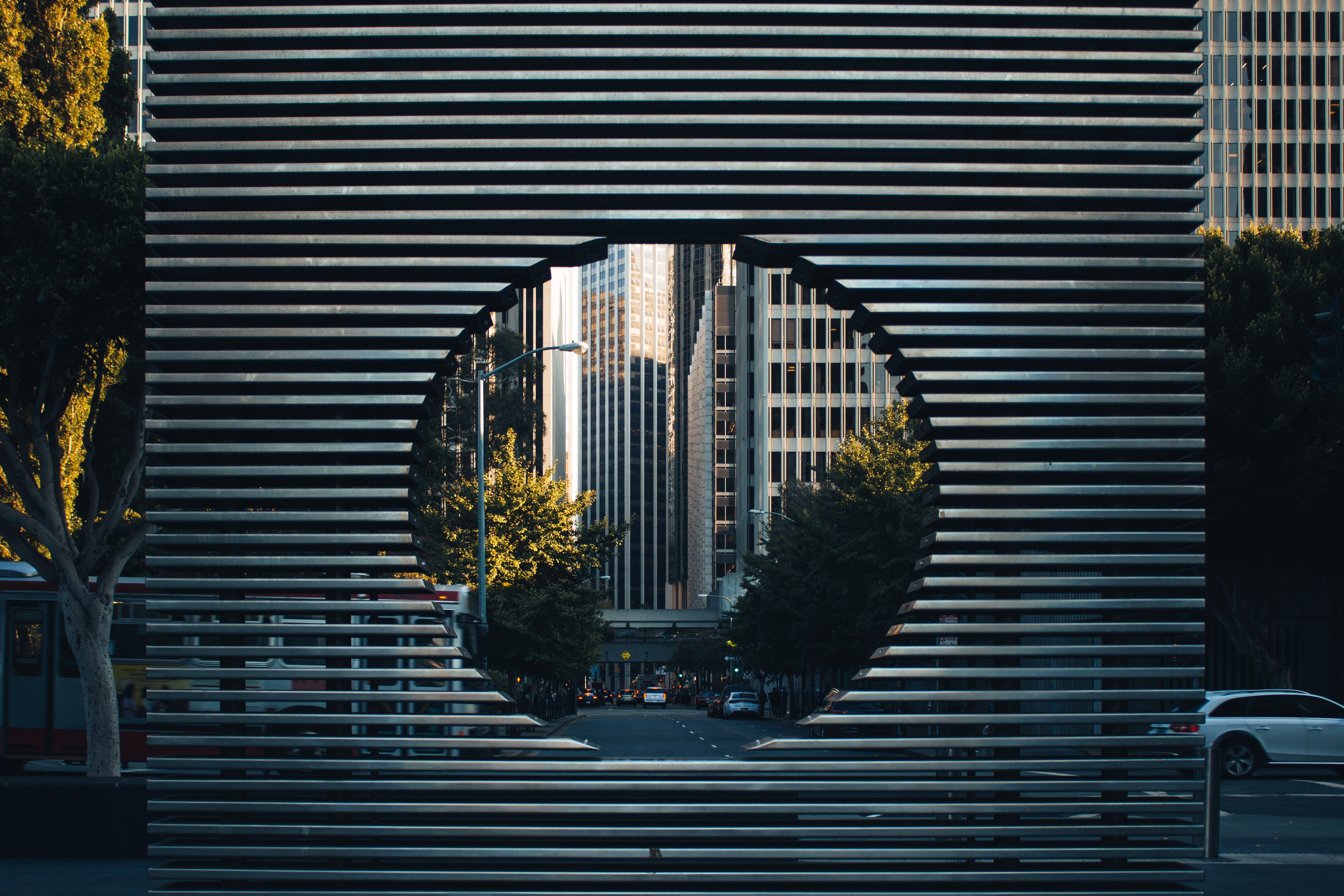 San Francisco sculpture with city buildings and trees HD Wallpaper