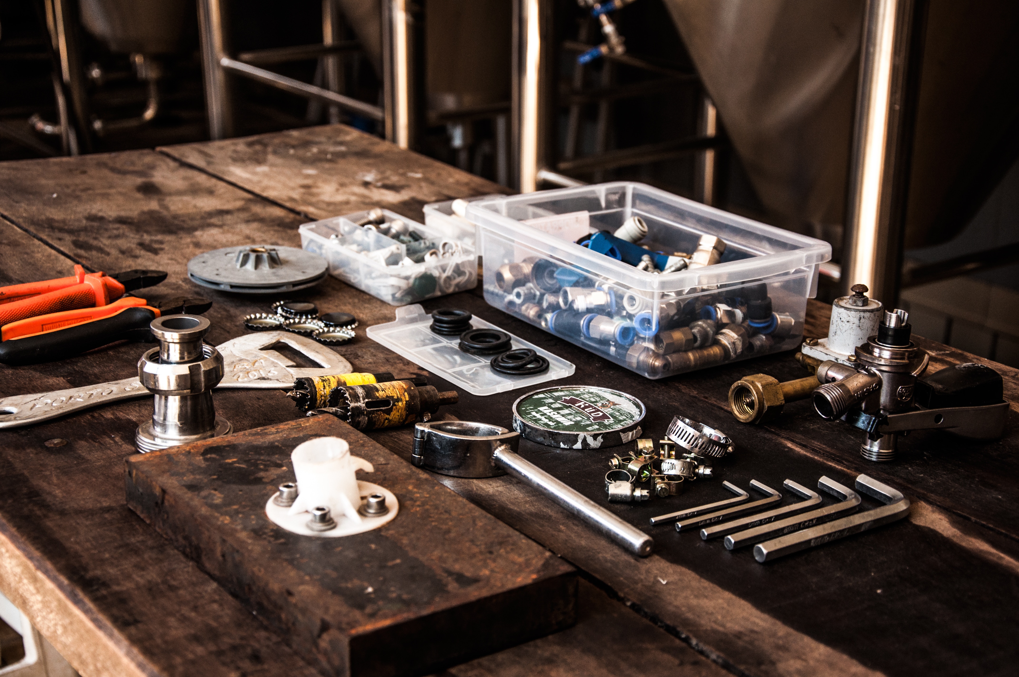 Plumbing tools and fittings on a wooden table HD Wallpaper