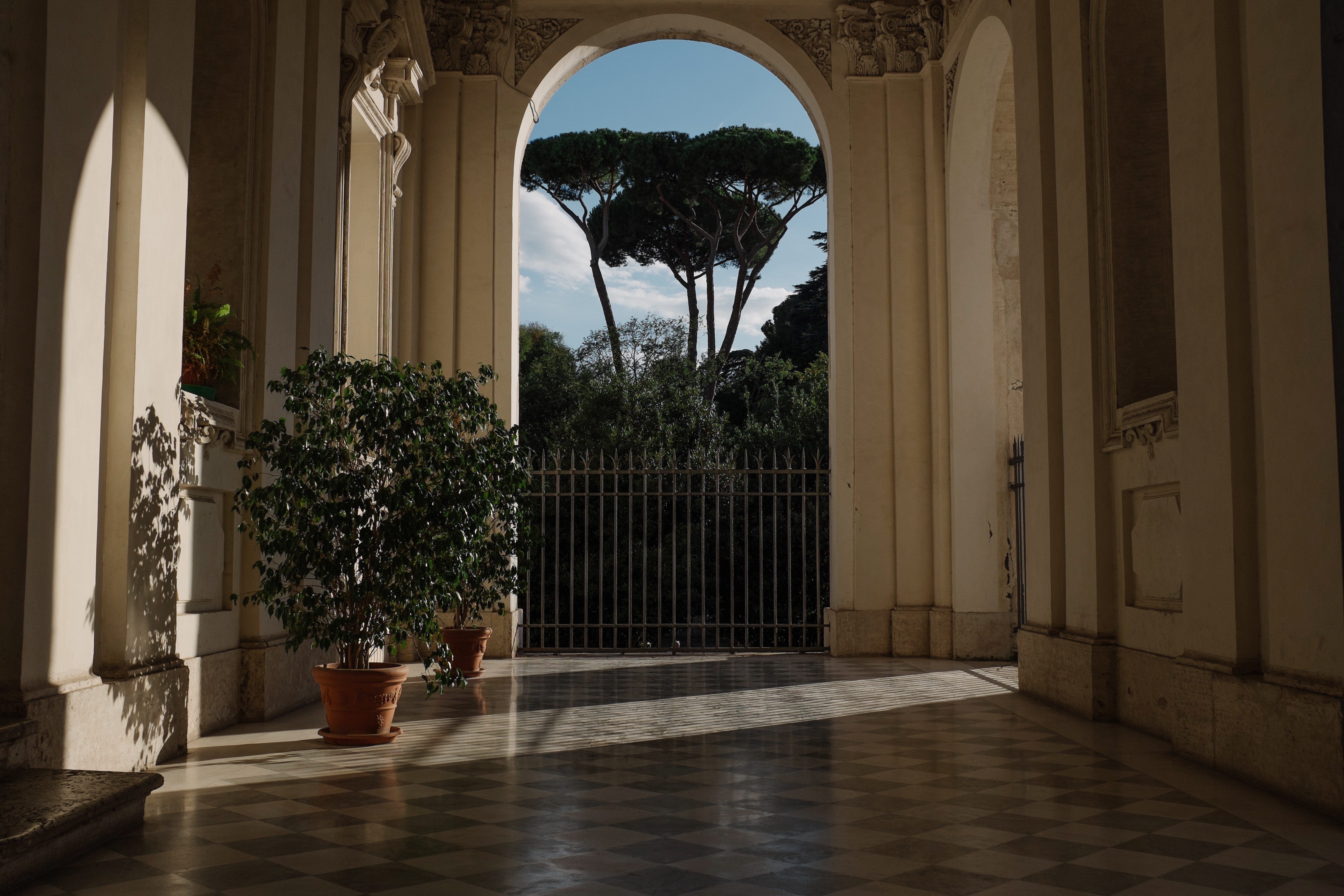 Archway view of trees and fence in Italy HD Wallpaper
