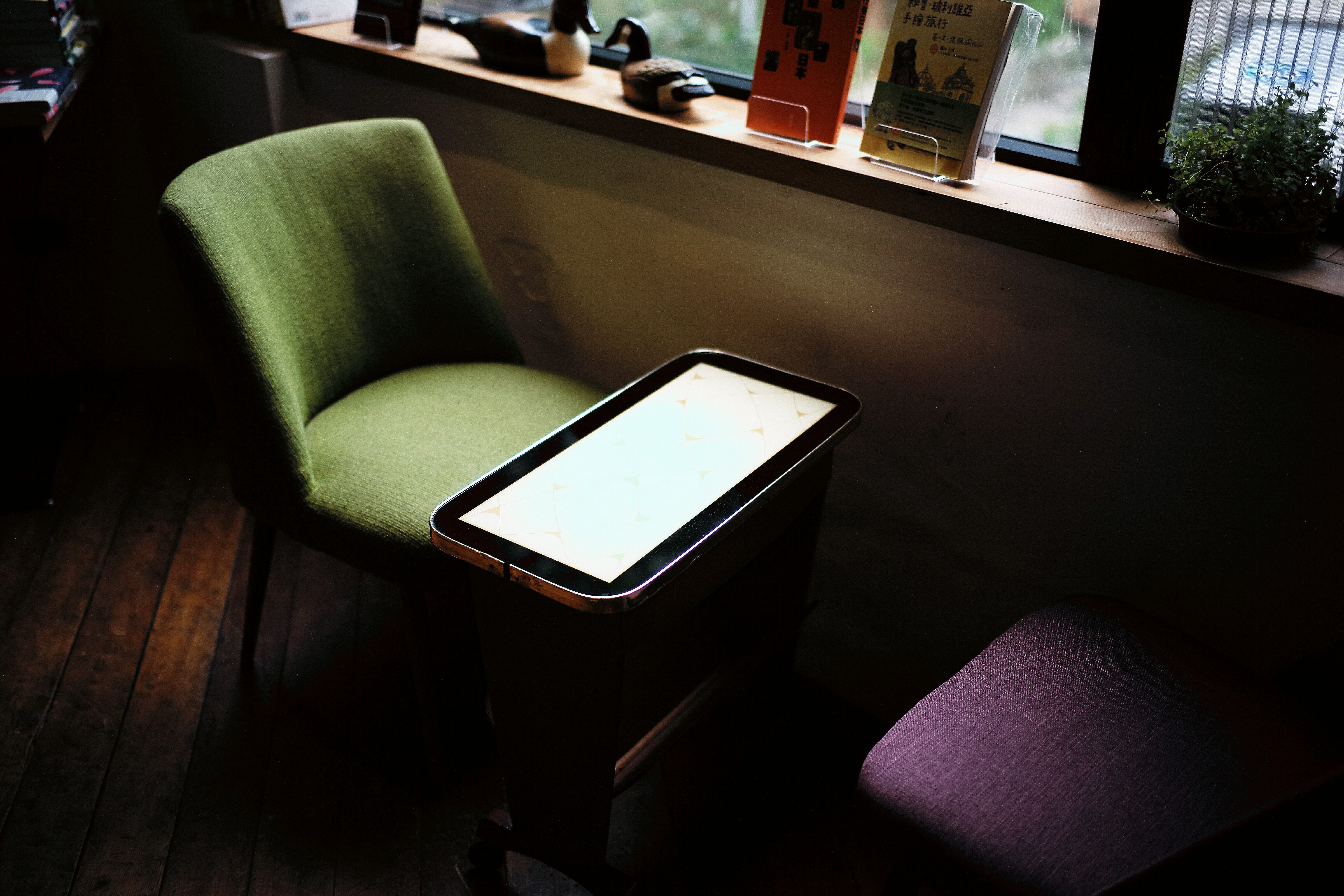 Table and chairs by a window with books HD Wallpaper