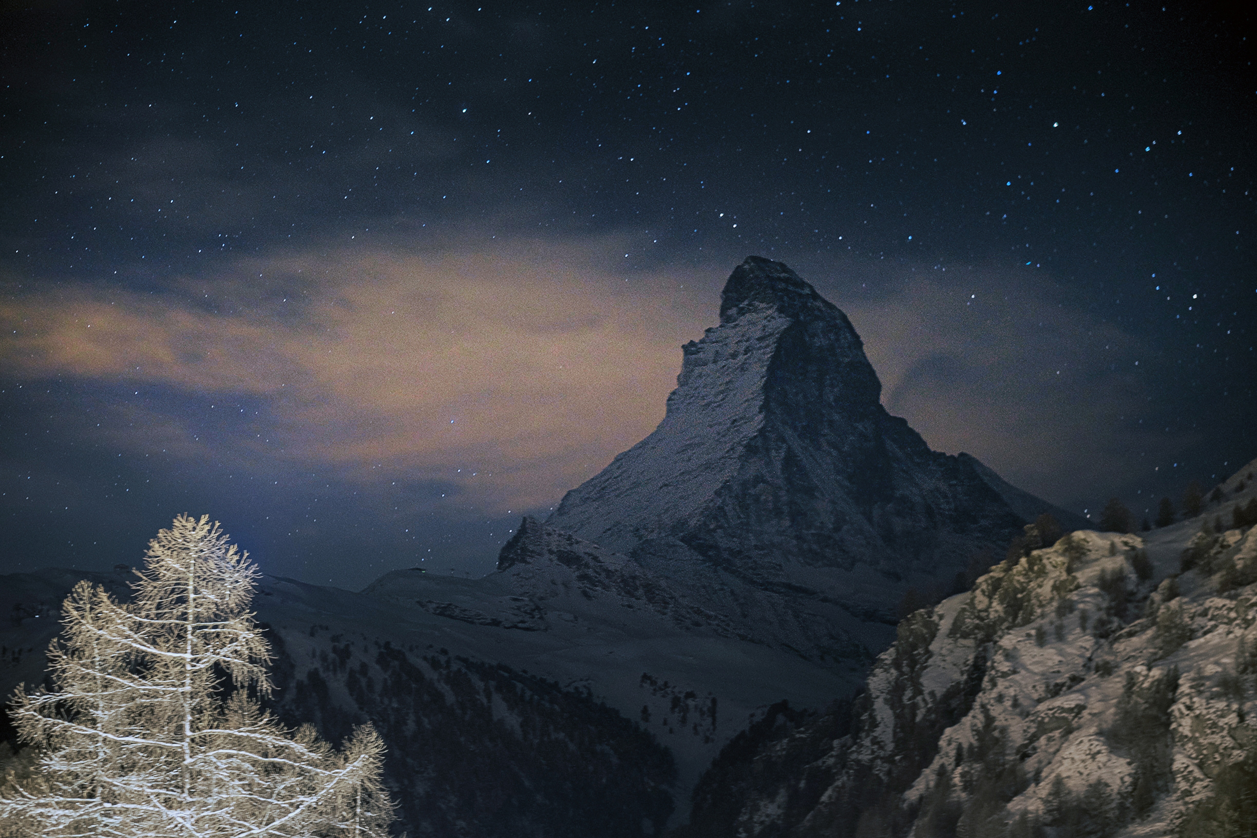 Matterhorn mountain at night with stars and clouds HD Wallpaper