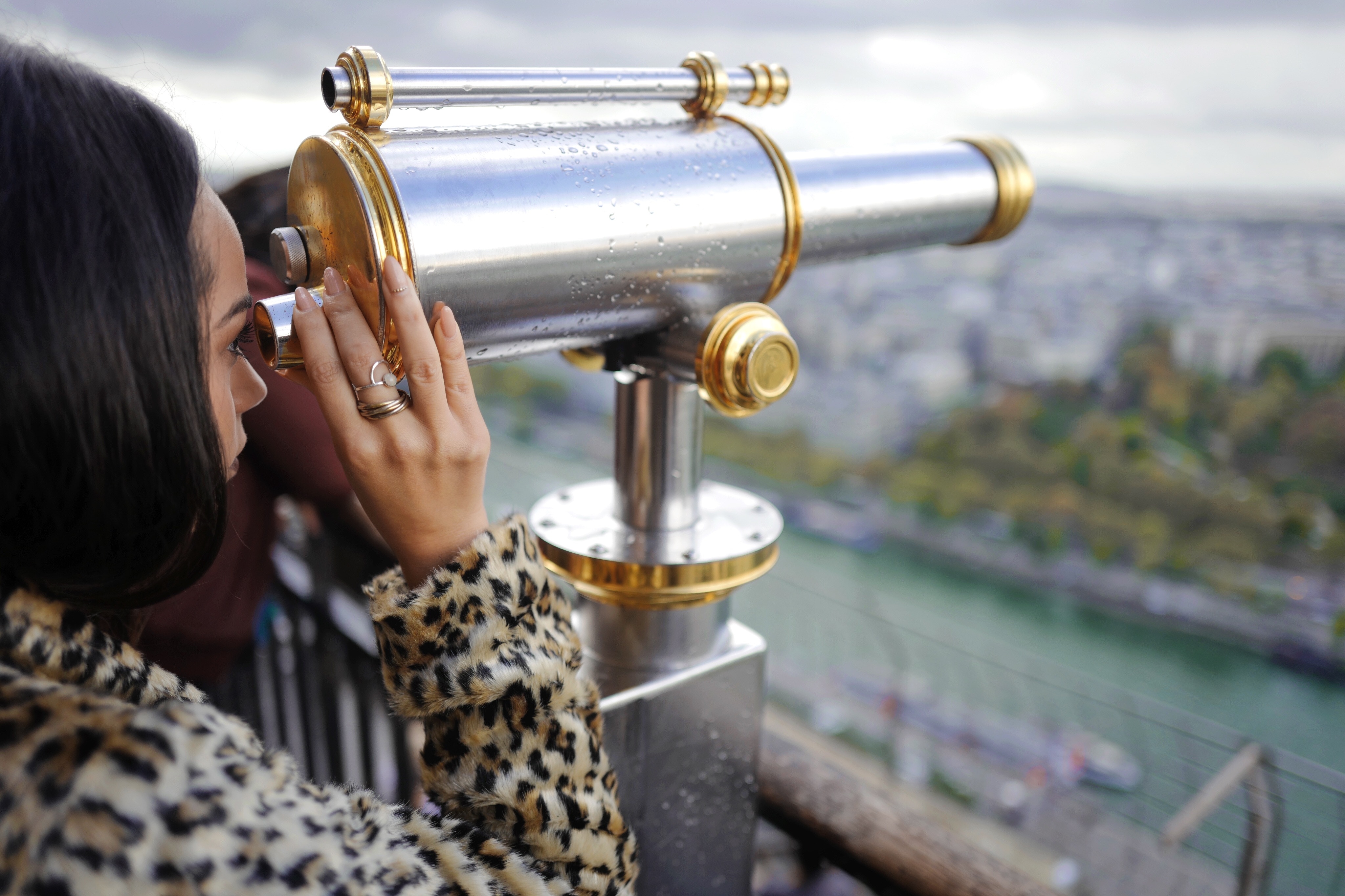 Woman looking through a telescope at a river overlook HD Wallpaper