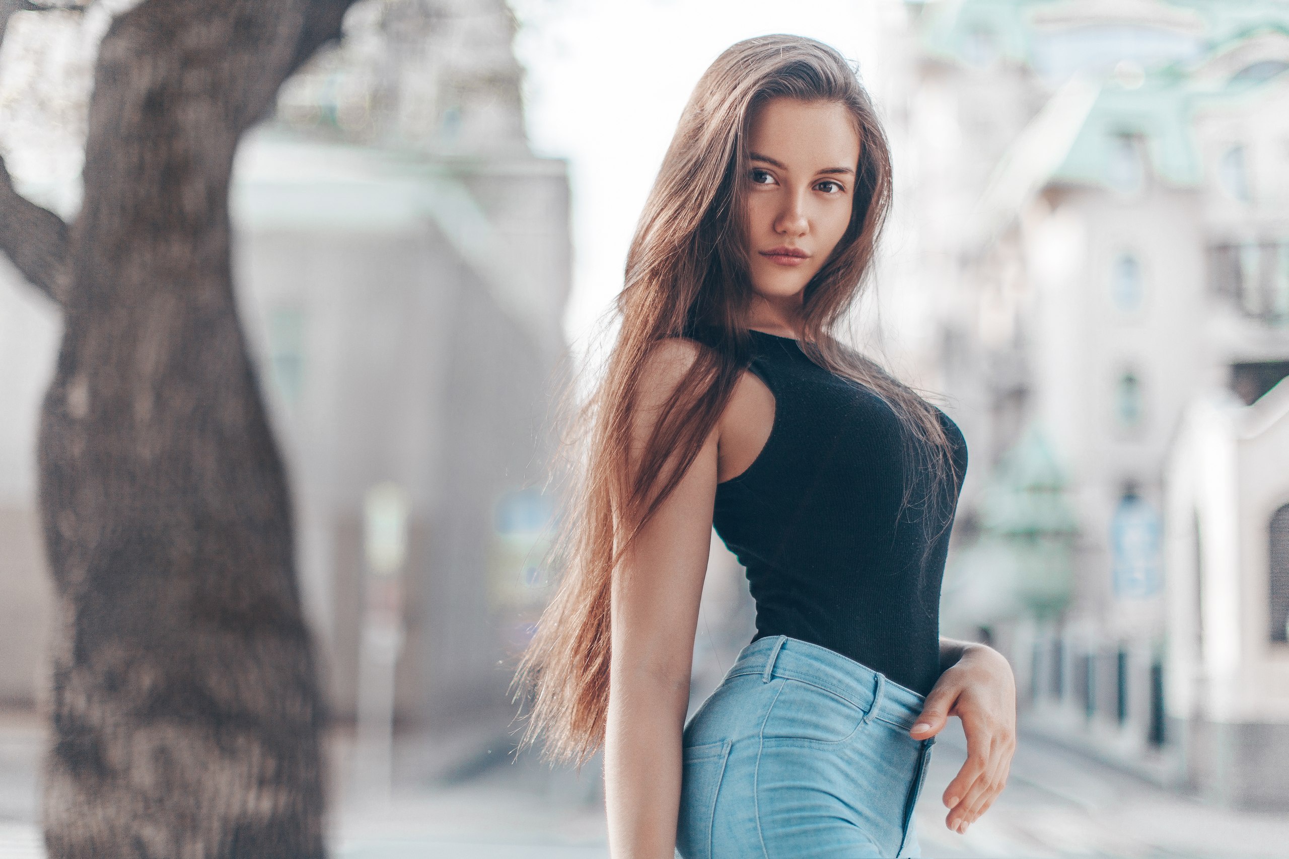 Brunette model in black top and jeans HD Wallpaper