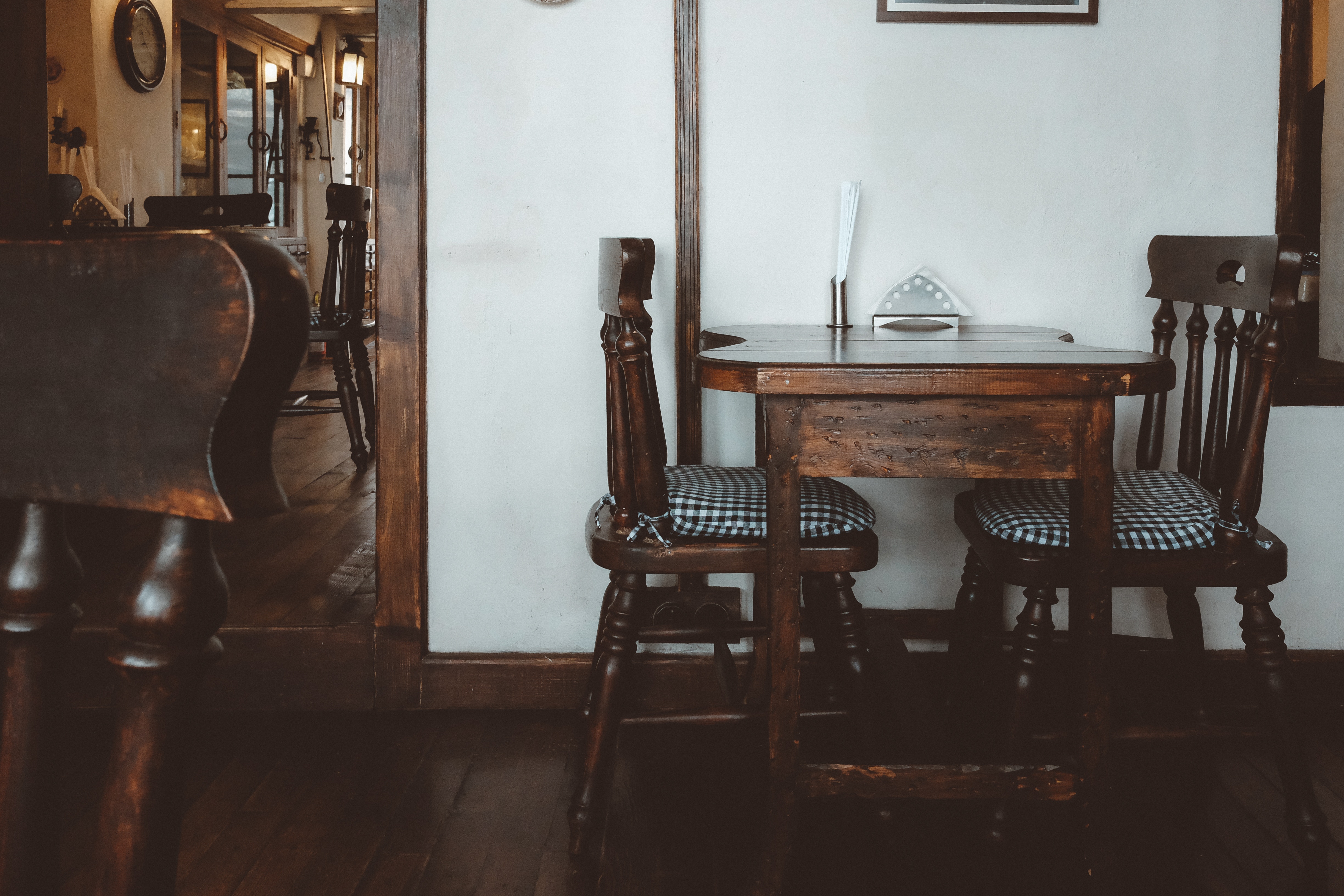 Wooden table and chairs in a cafe HD Wallpaper
