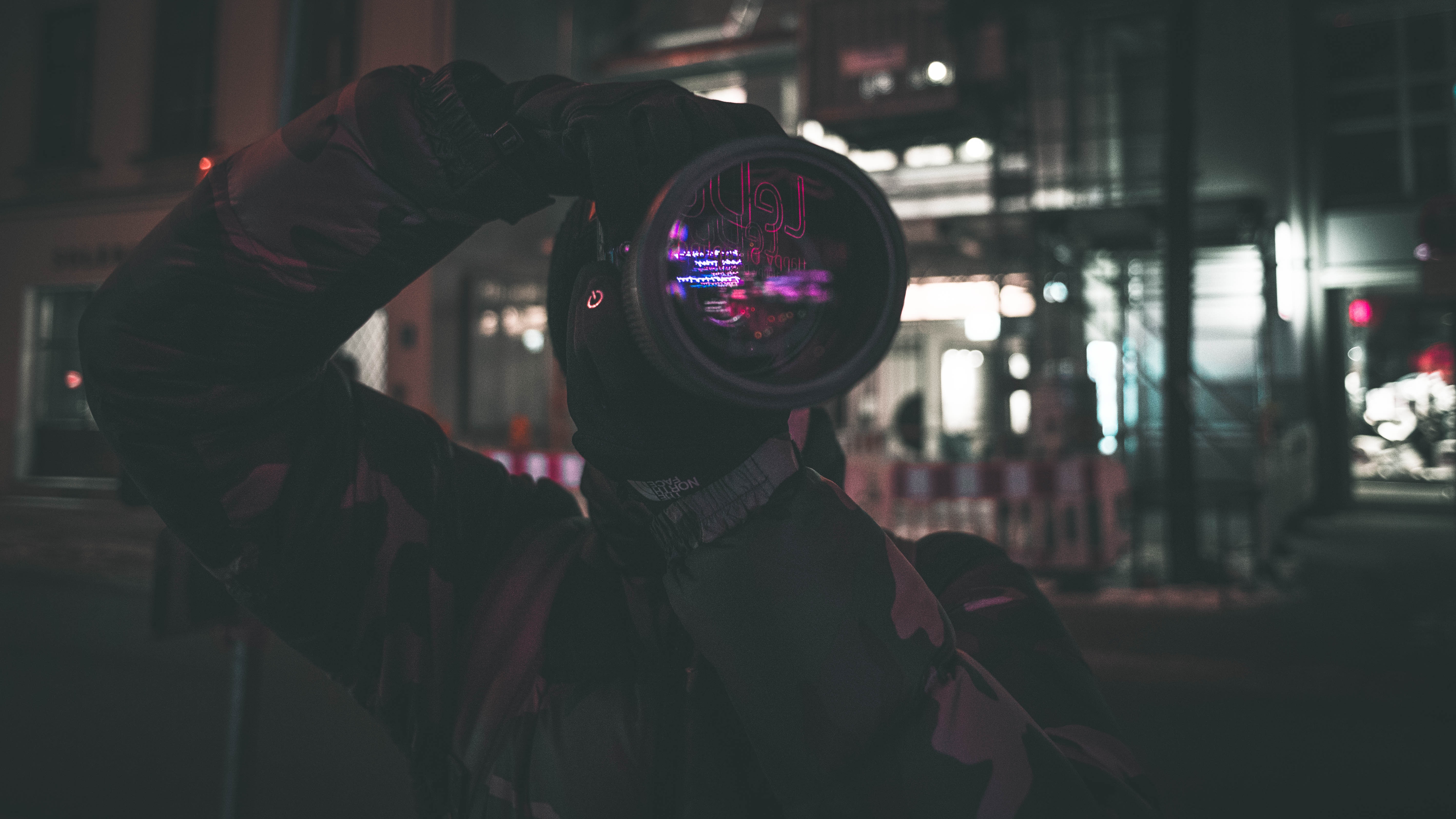 Photographer with camera lens at night in Germany HD Wallpaper
