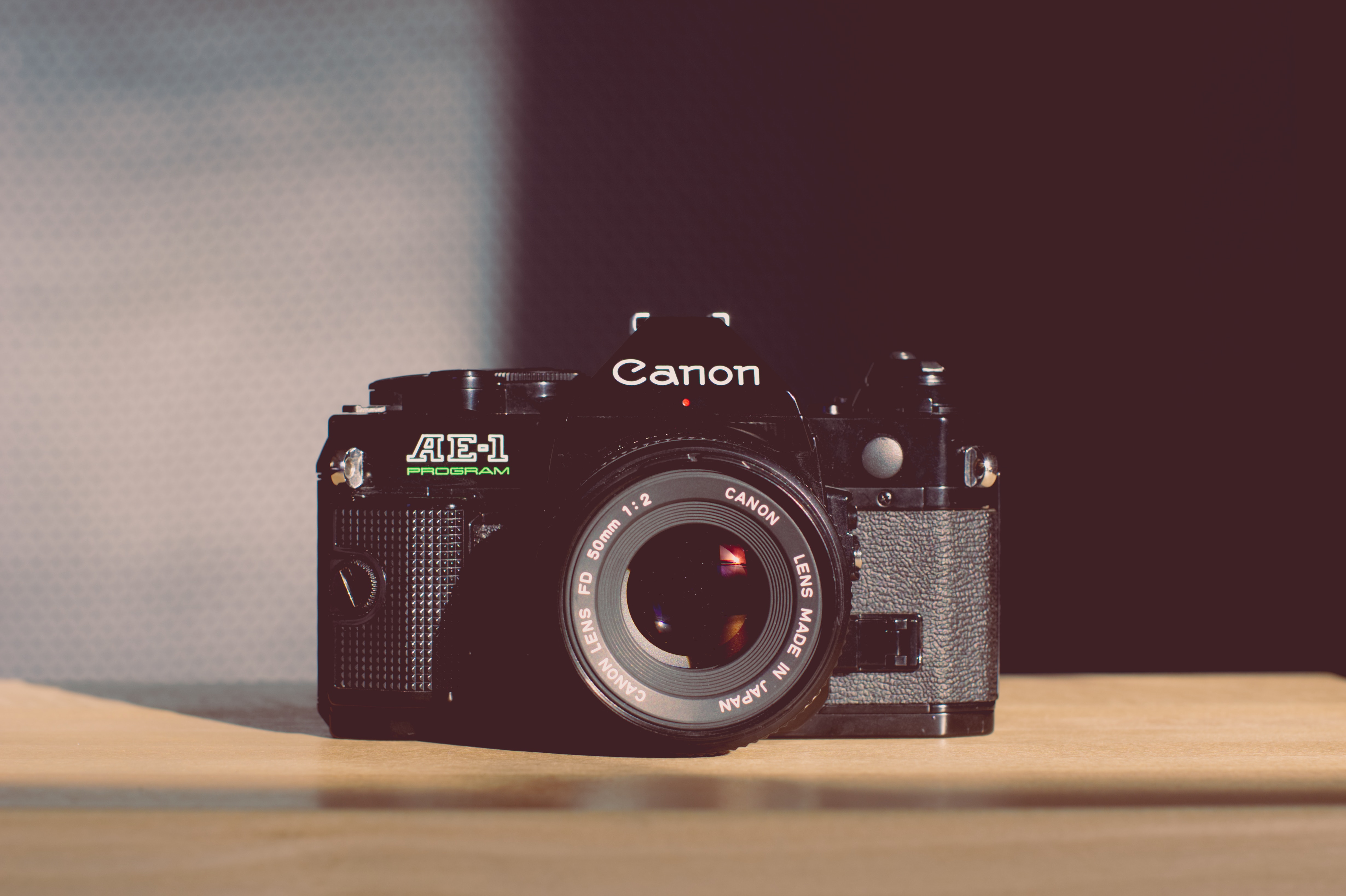 Black Canon AE-1 Program vintage camera with 50mm lens HD Wallpaper