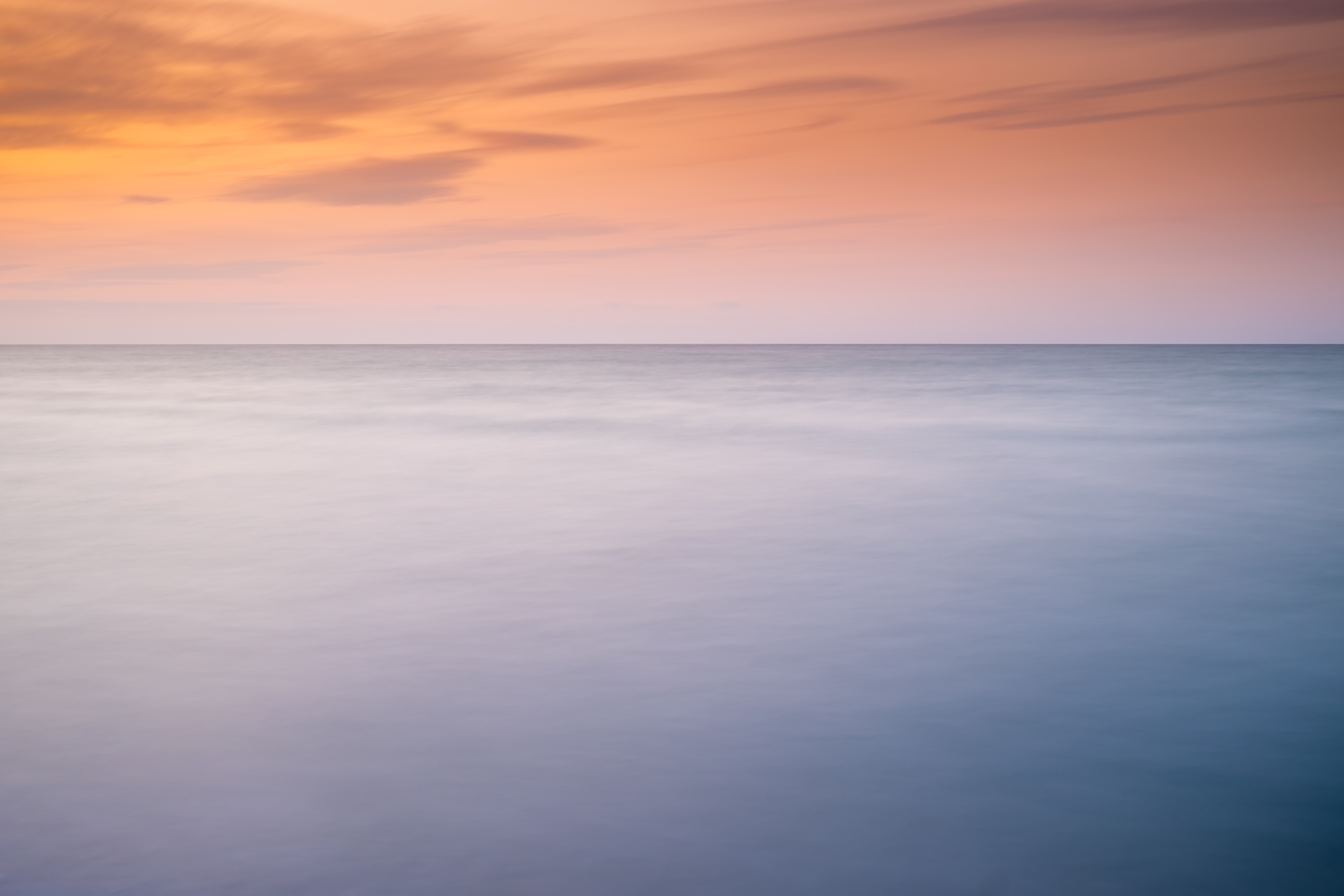 Minimalist ocean horizon at sunset with orange sky HD Wallpaper
