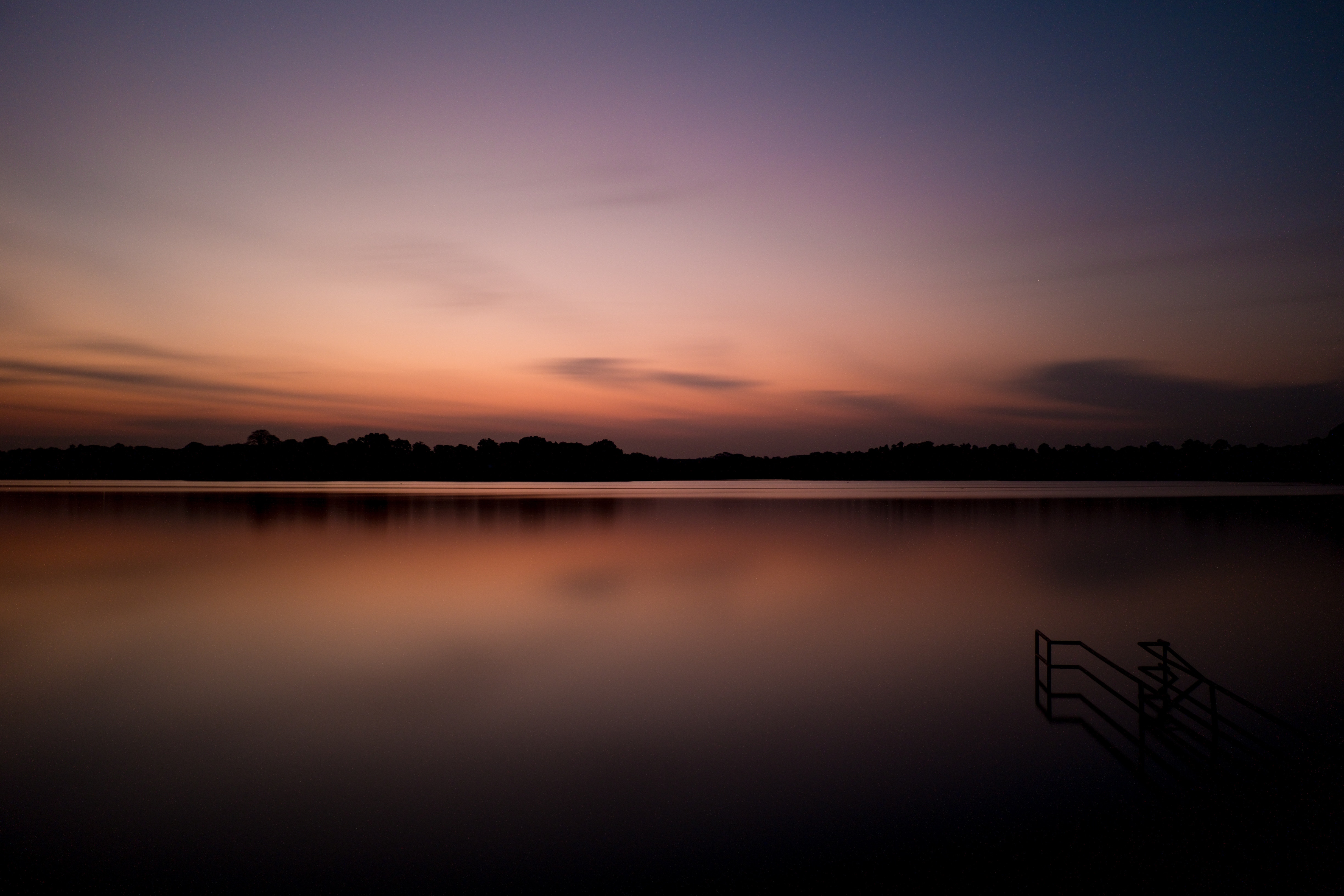 Long exposure of a lake at sunset with stairs HD Wallpaper