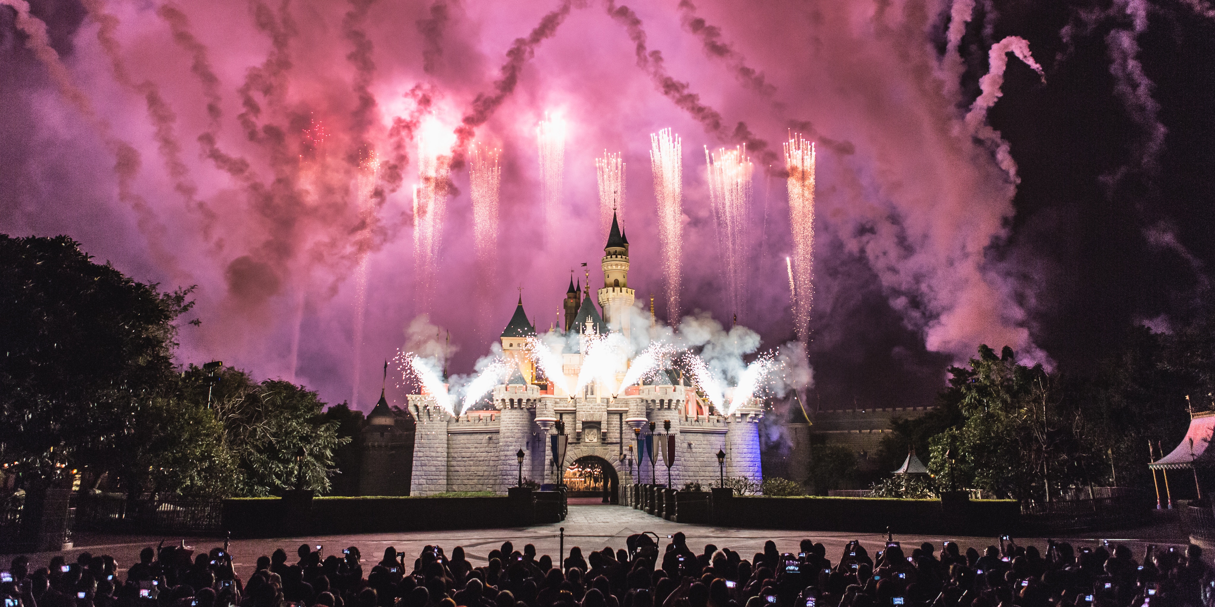 Disneyland castle fireworks show with crowd HD Wallpaper
