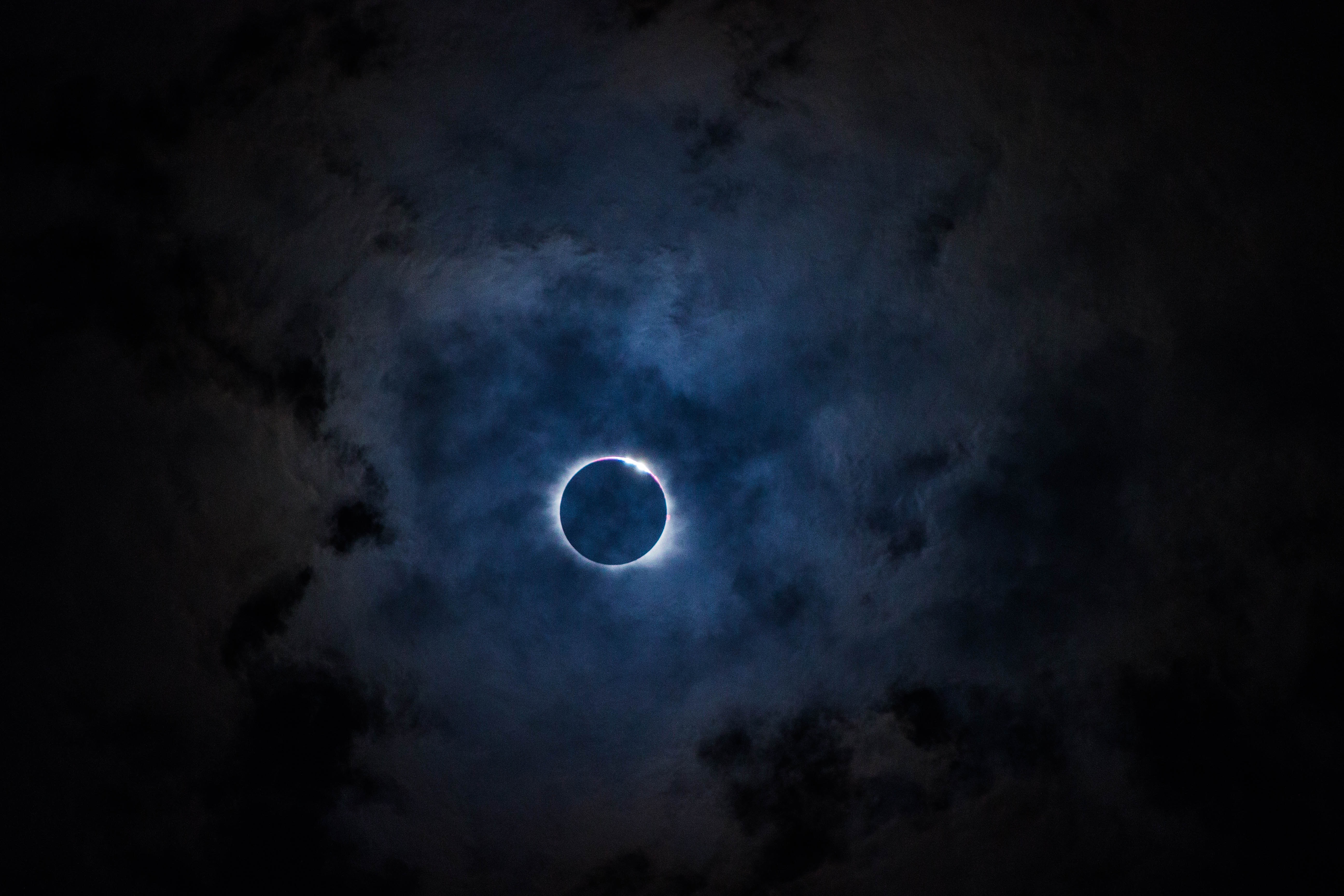 Solar eclipse with clouds at night HD Wallpaper