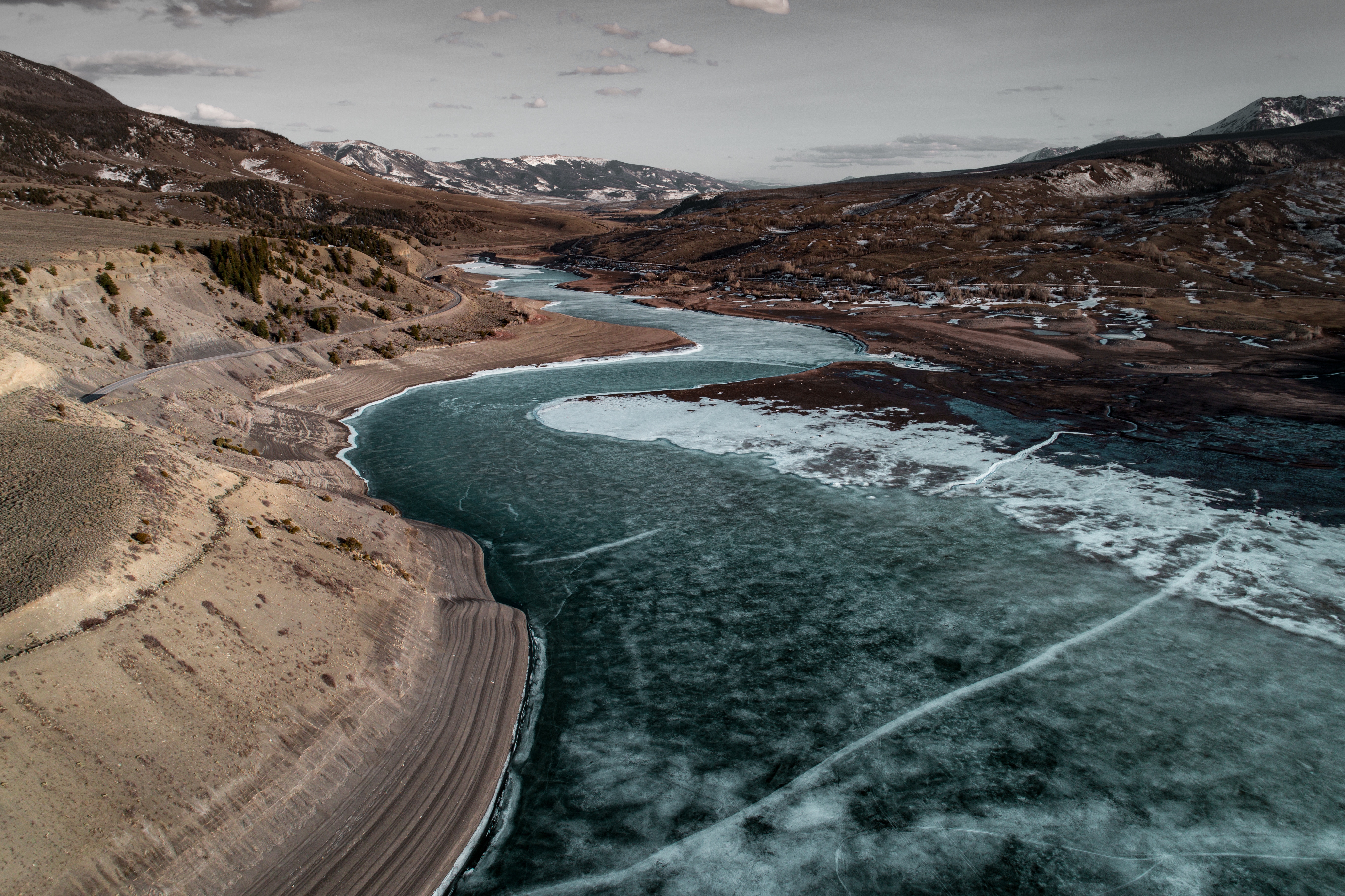 Frozen River Winding Through Mountains HD Wallpaper