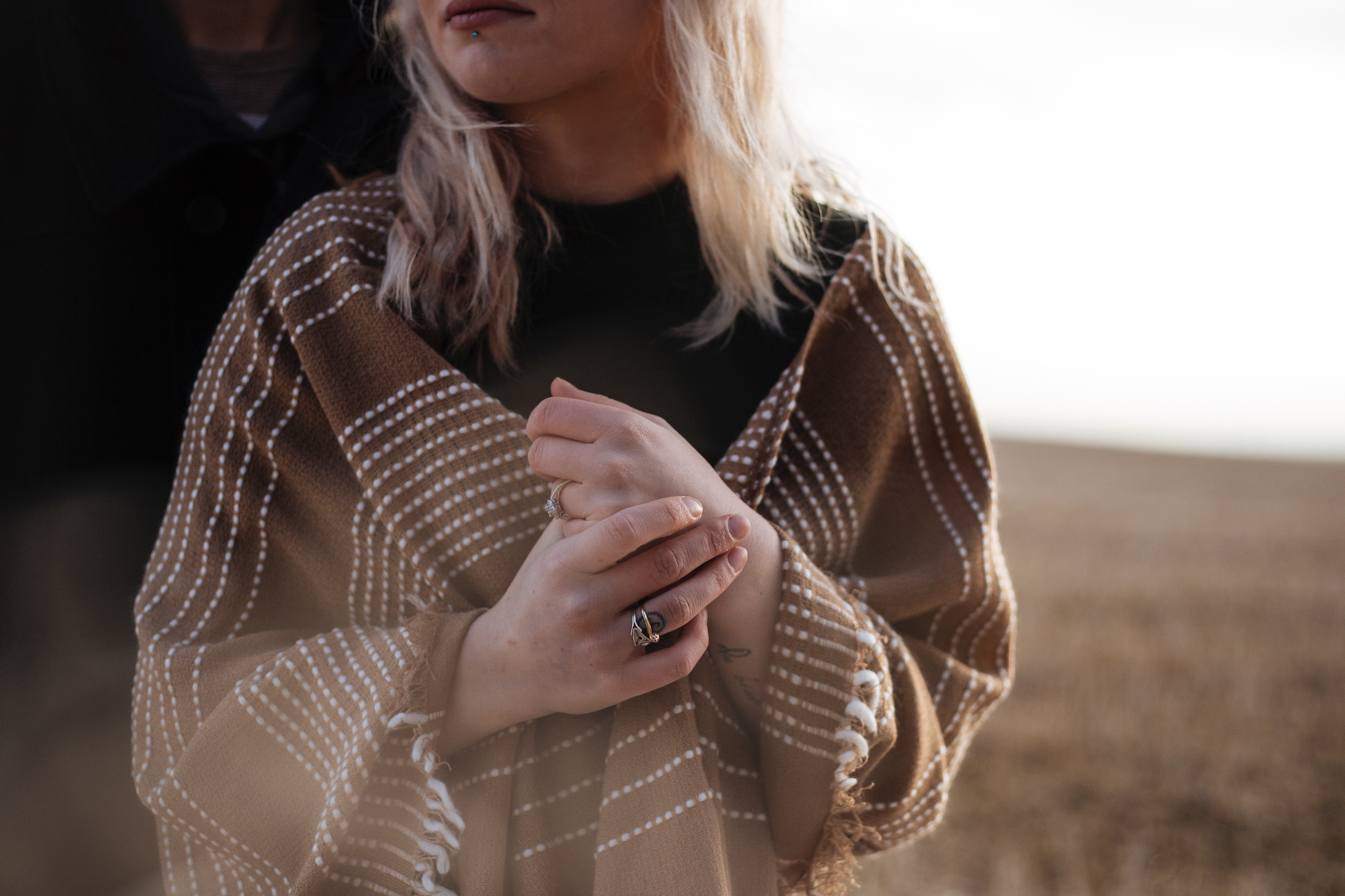 Woman wearing a brown shawl with white pattern HD Wallpaper