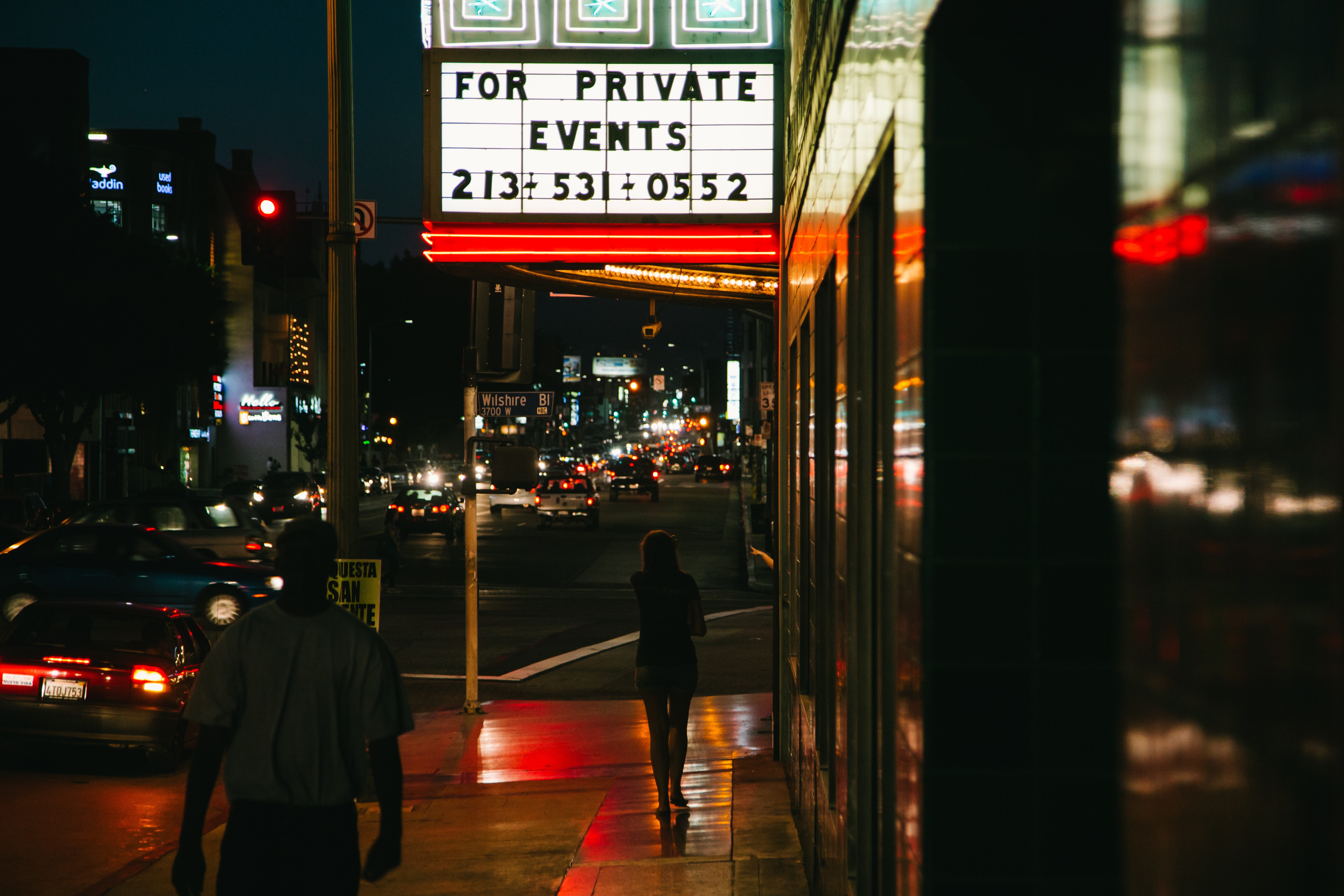 Neon sign for private events on a city street at night HD Wallpaper