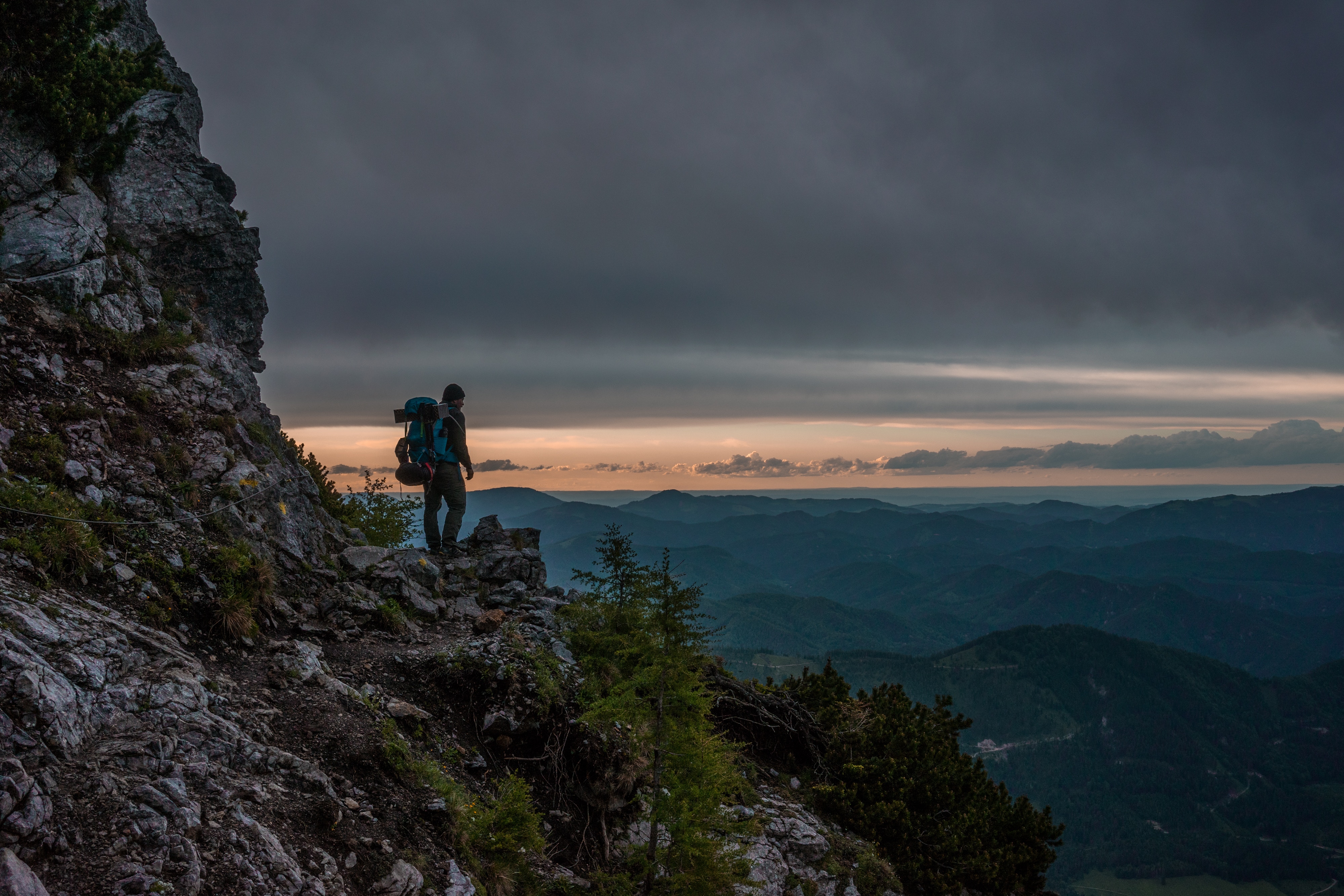 Hiker on a mountain ridge at sunset in Austria HD Wallpaper