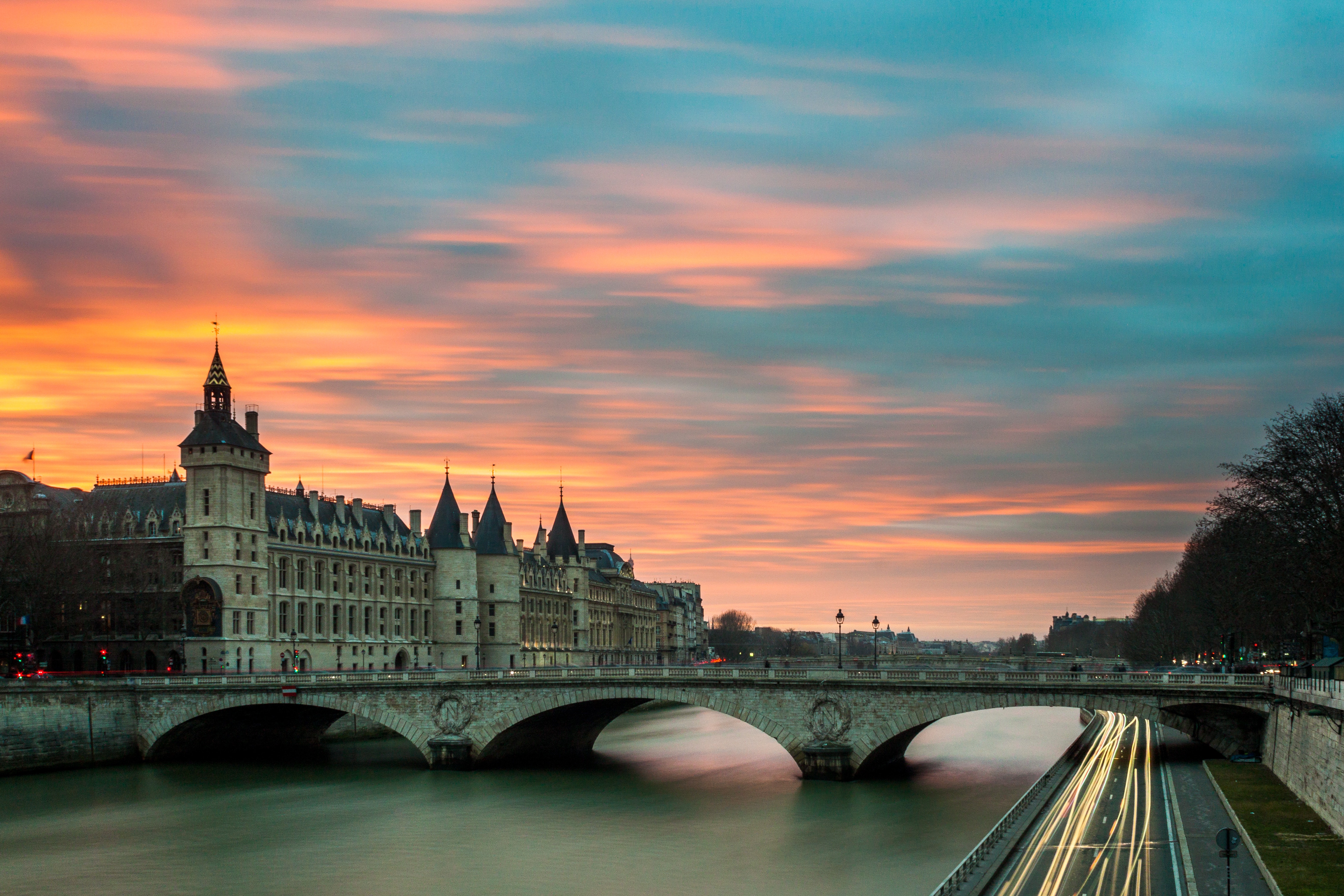 Parisian bridge over the Seine river at sunset HD Wallpaper