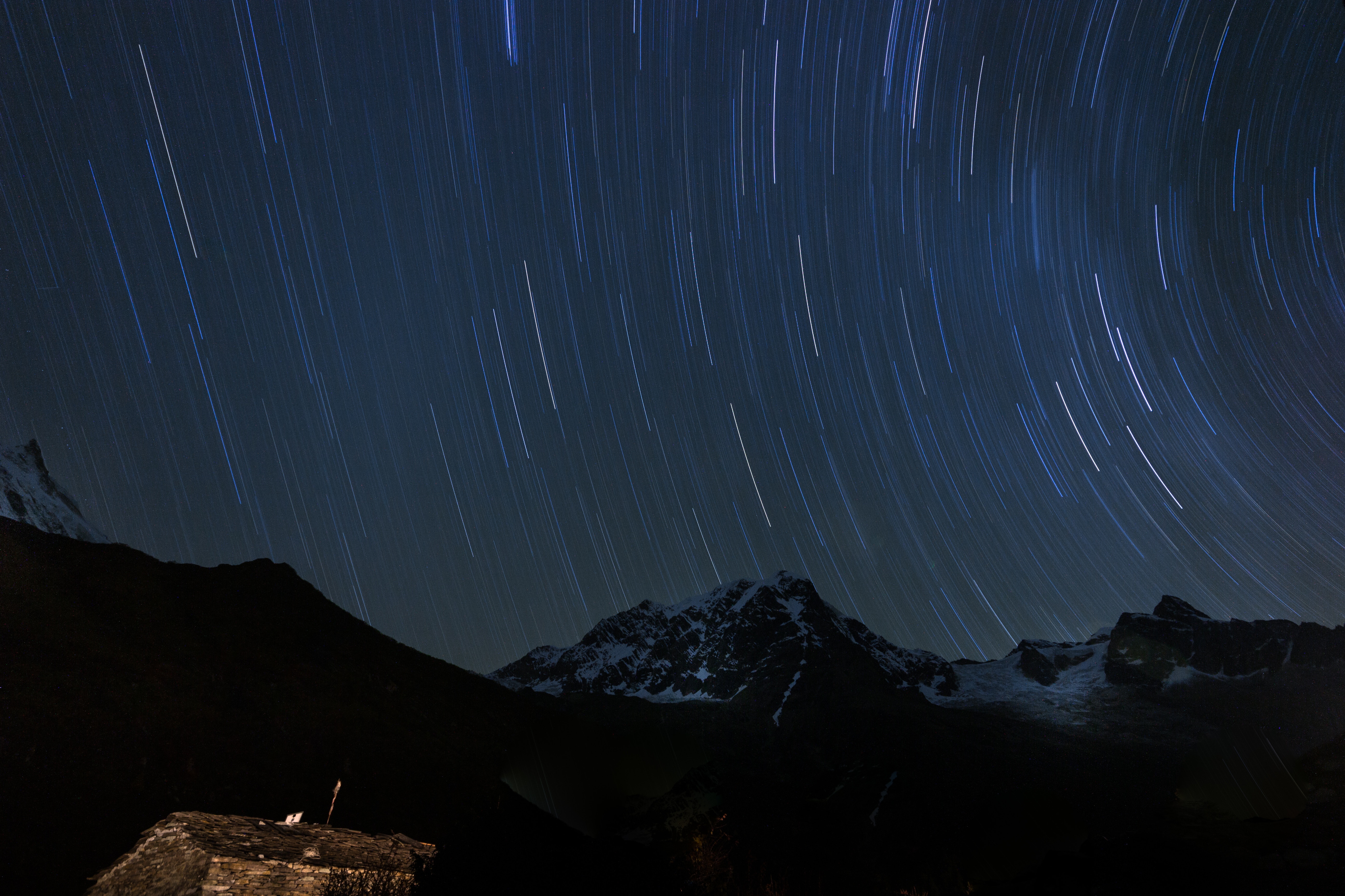 Star trails over snow-capped mountains in Nepal HD Wallpaper