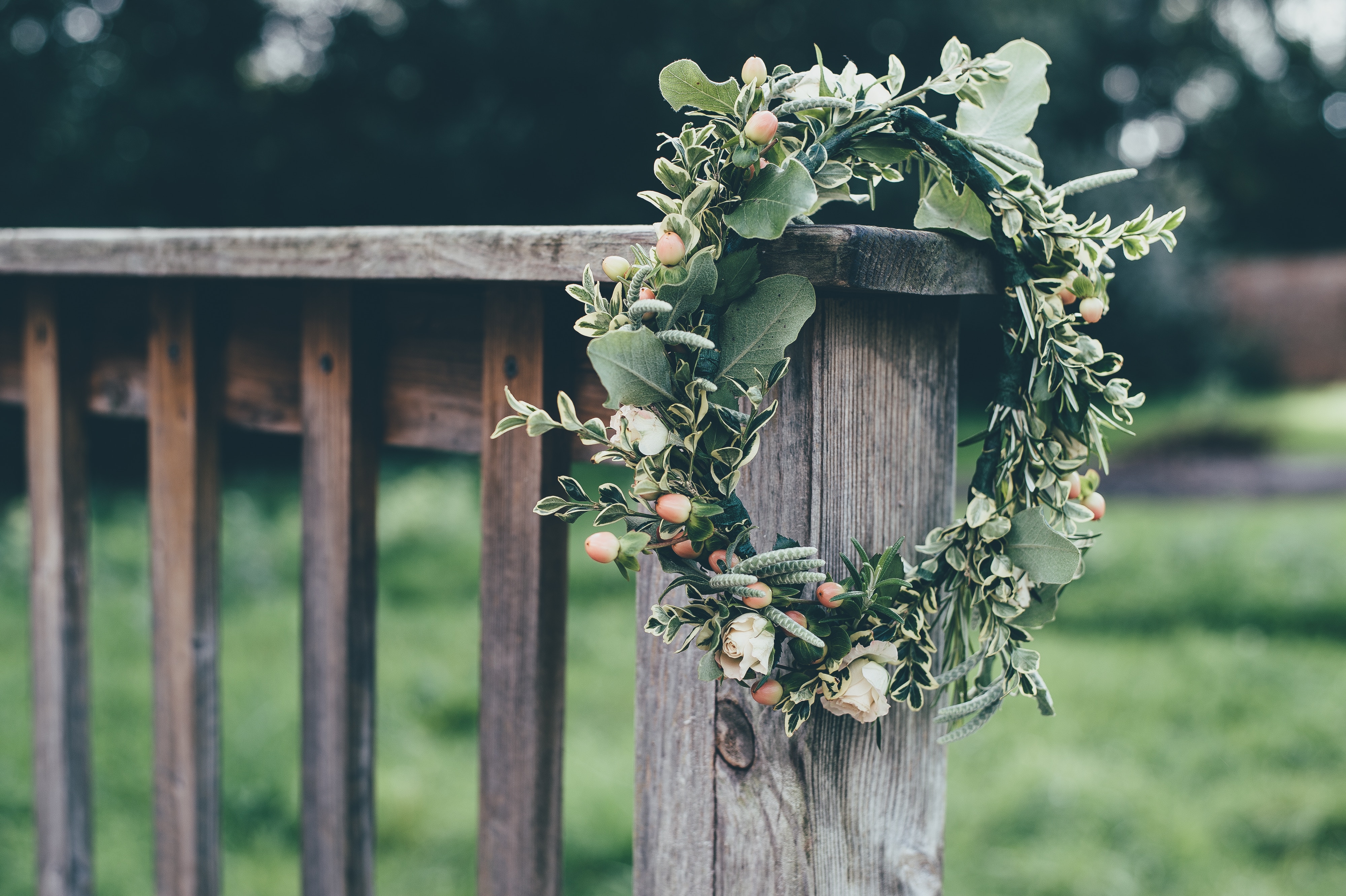 Floral crown with berries and roses on a wooden fence HD Wallpaper