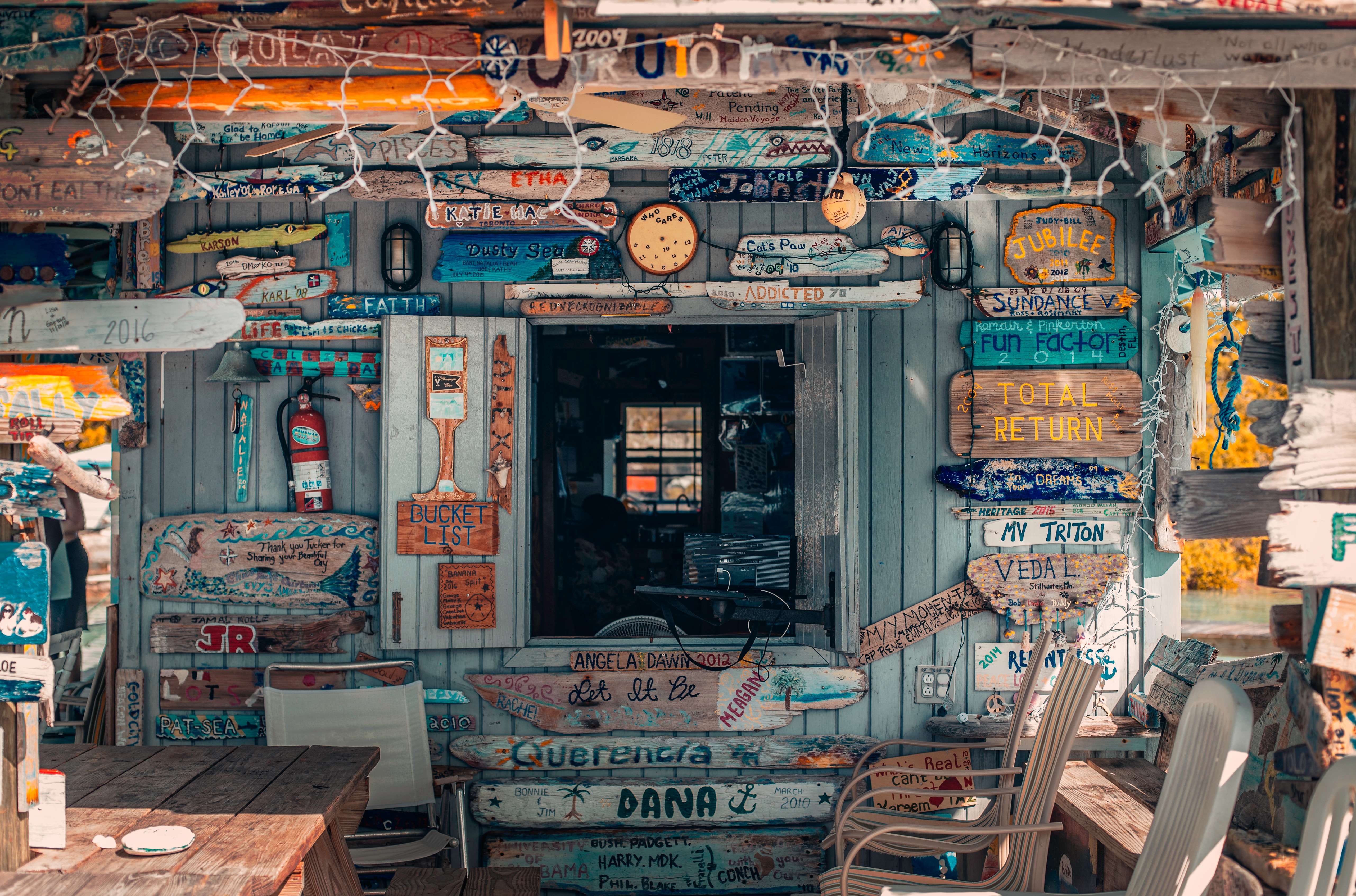 Shop decorated with numerous signs and driftwood HD Wallpaper